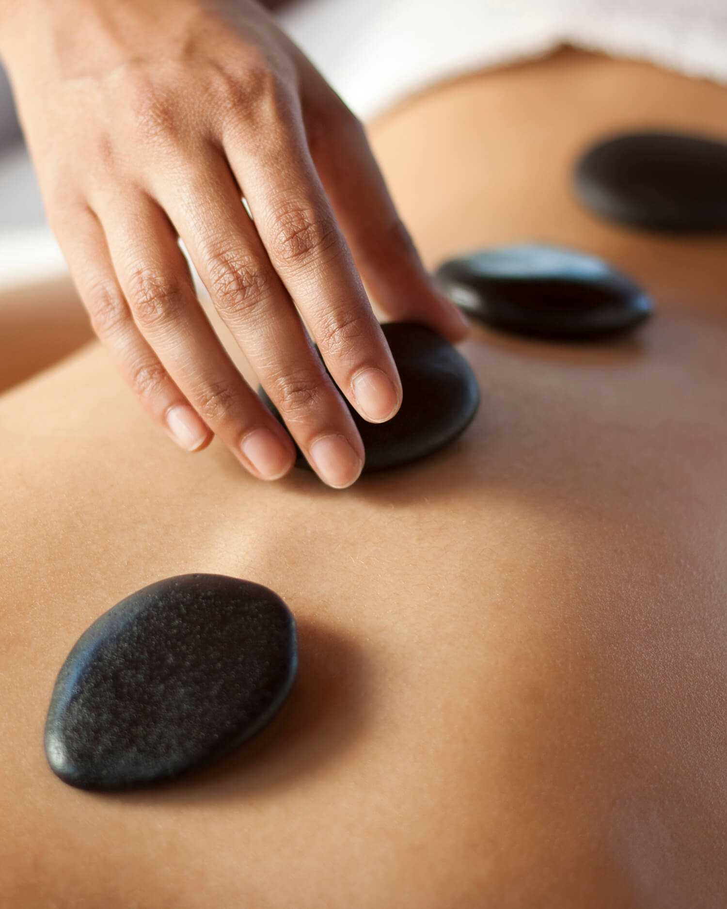 A woman getting a hot stone massage