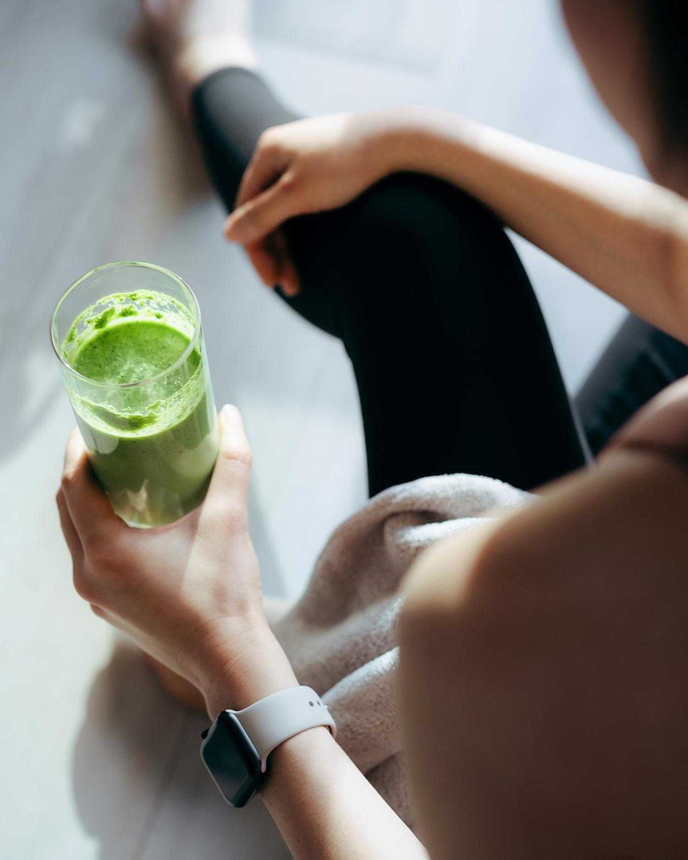 A woman drinking a smoothie