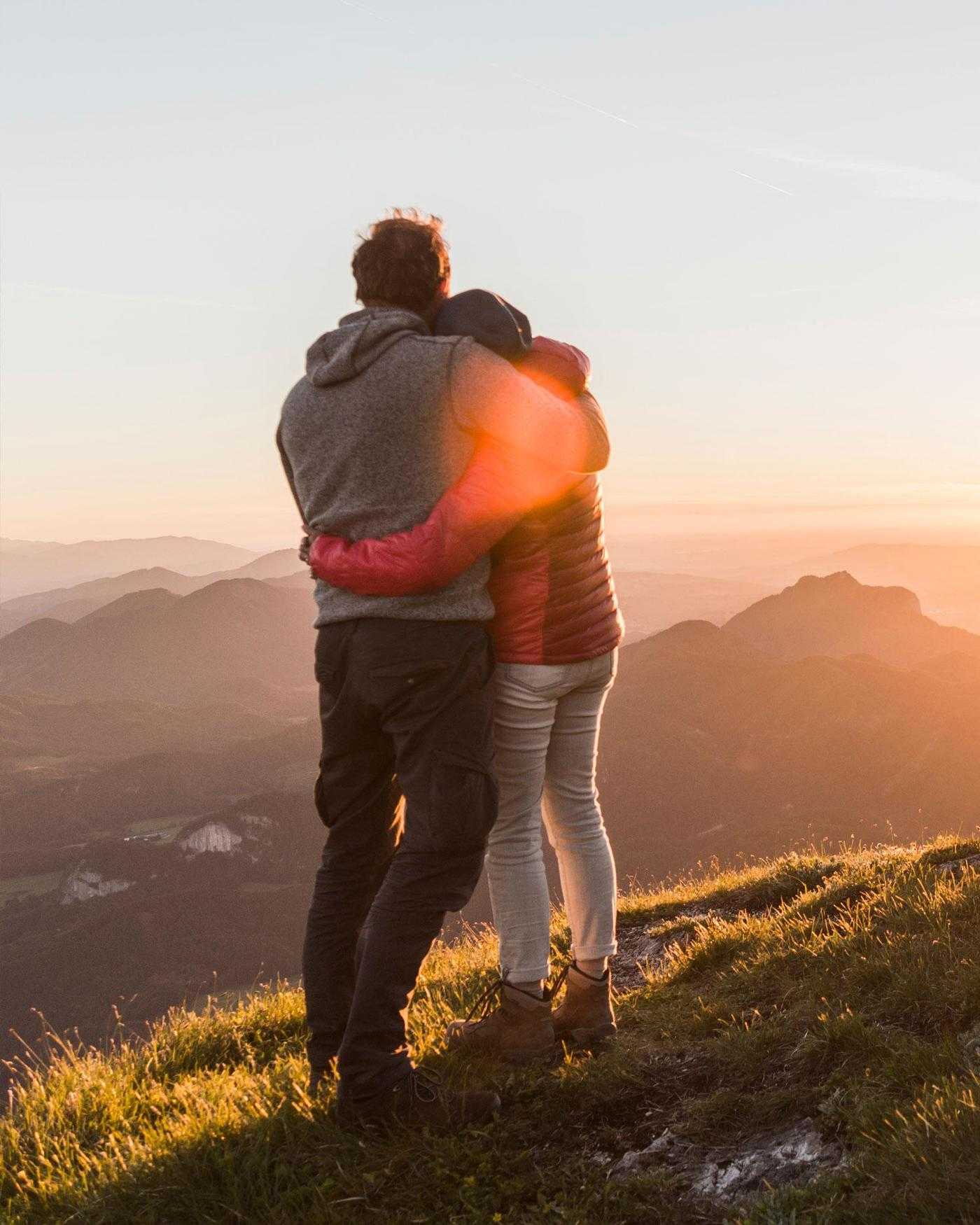 A man and woman watching a sunset