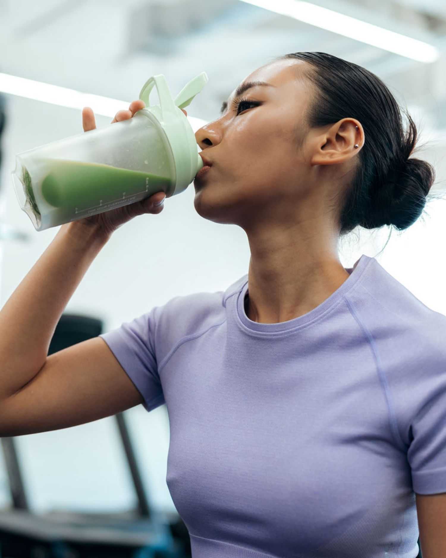 a woman drinking a smoothie
