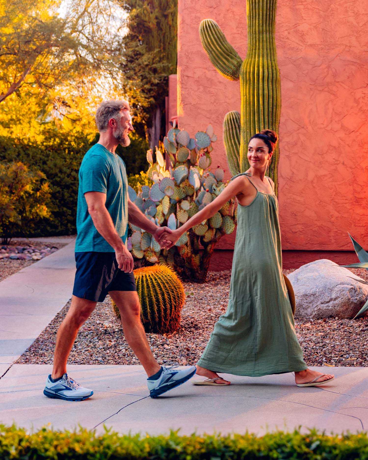 A man and woman holding hands and walking