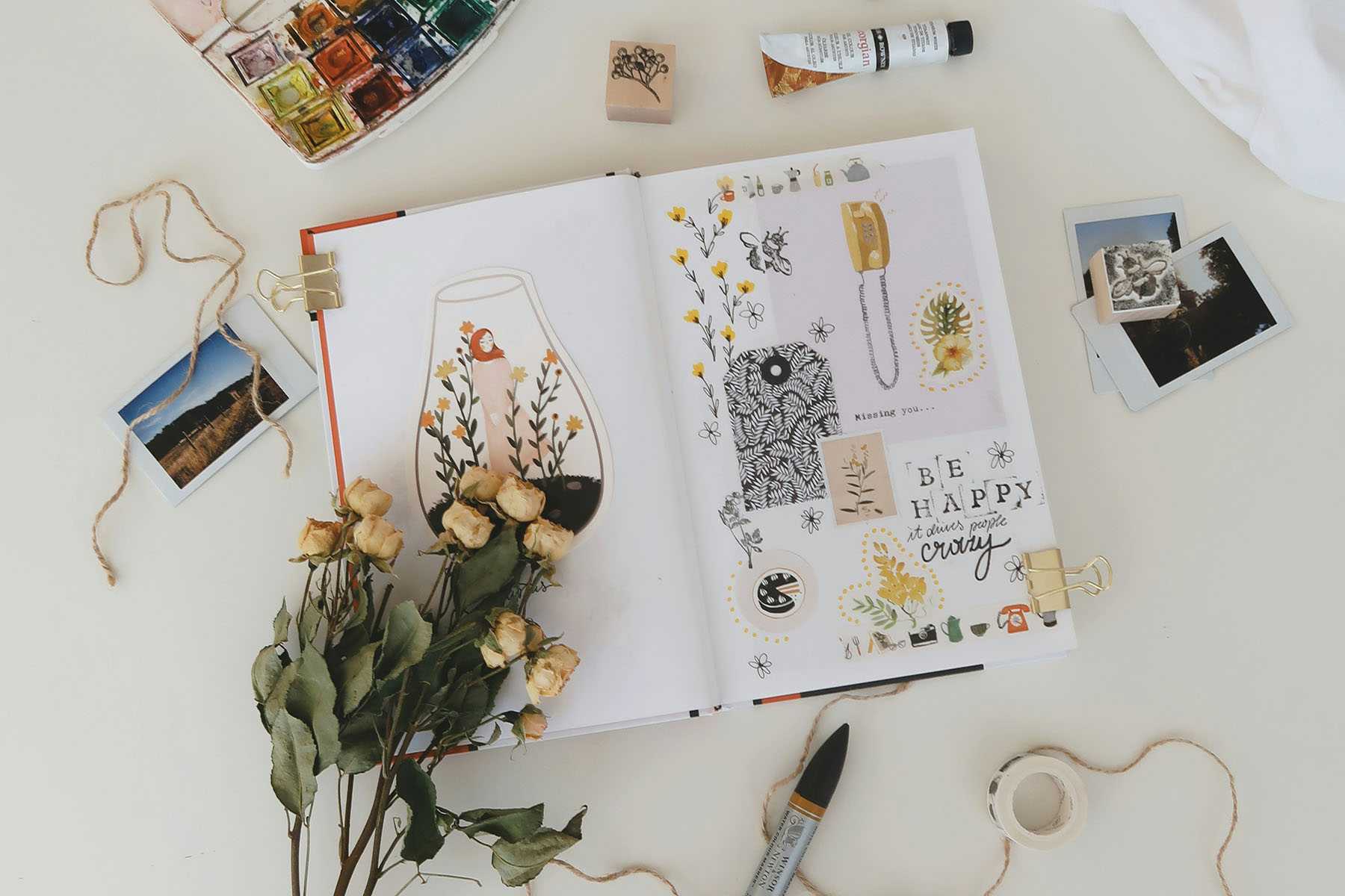 a display of flowers and craft pieces over a scrap book