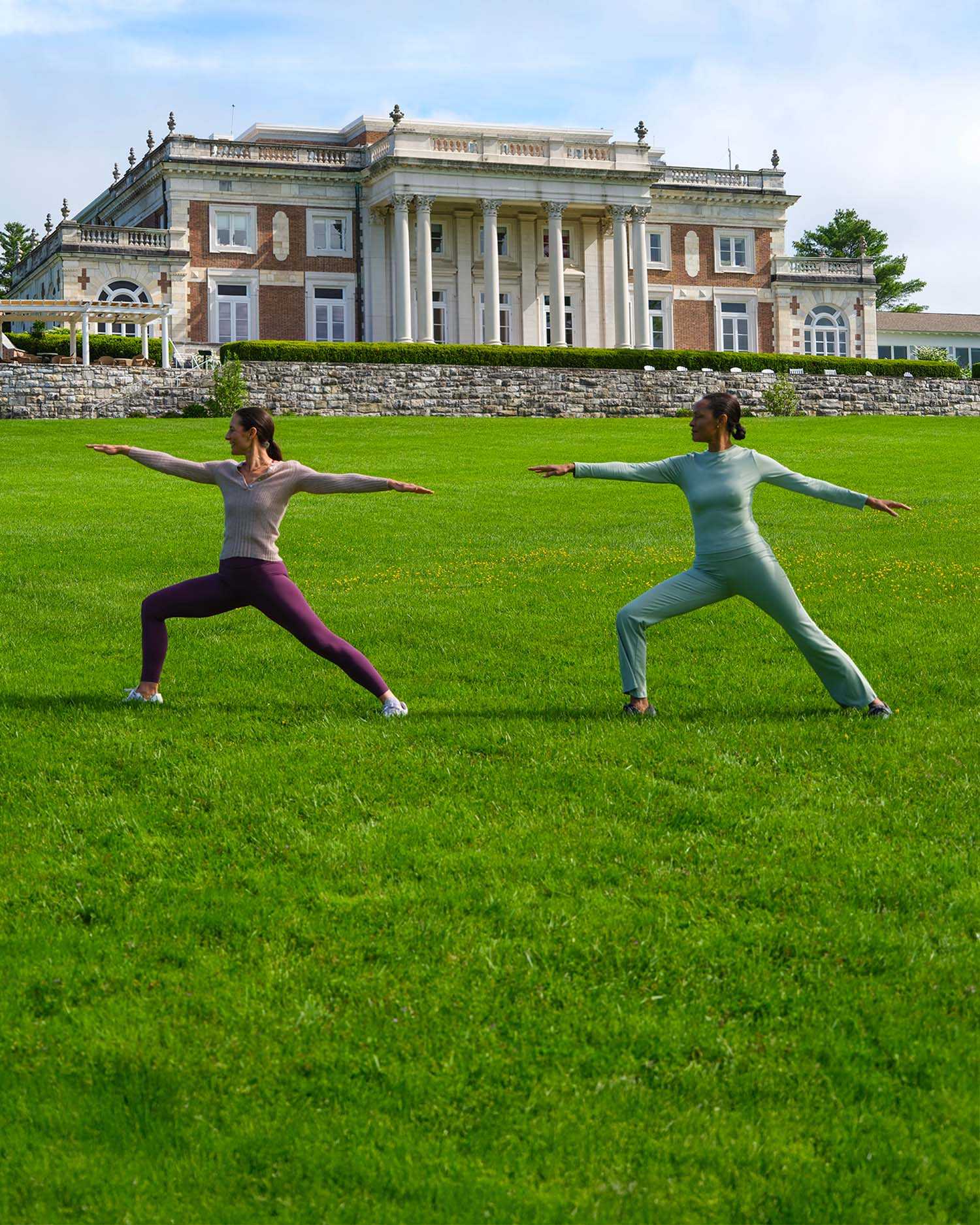 two women working out in front of the Lenox Mansion