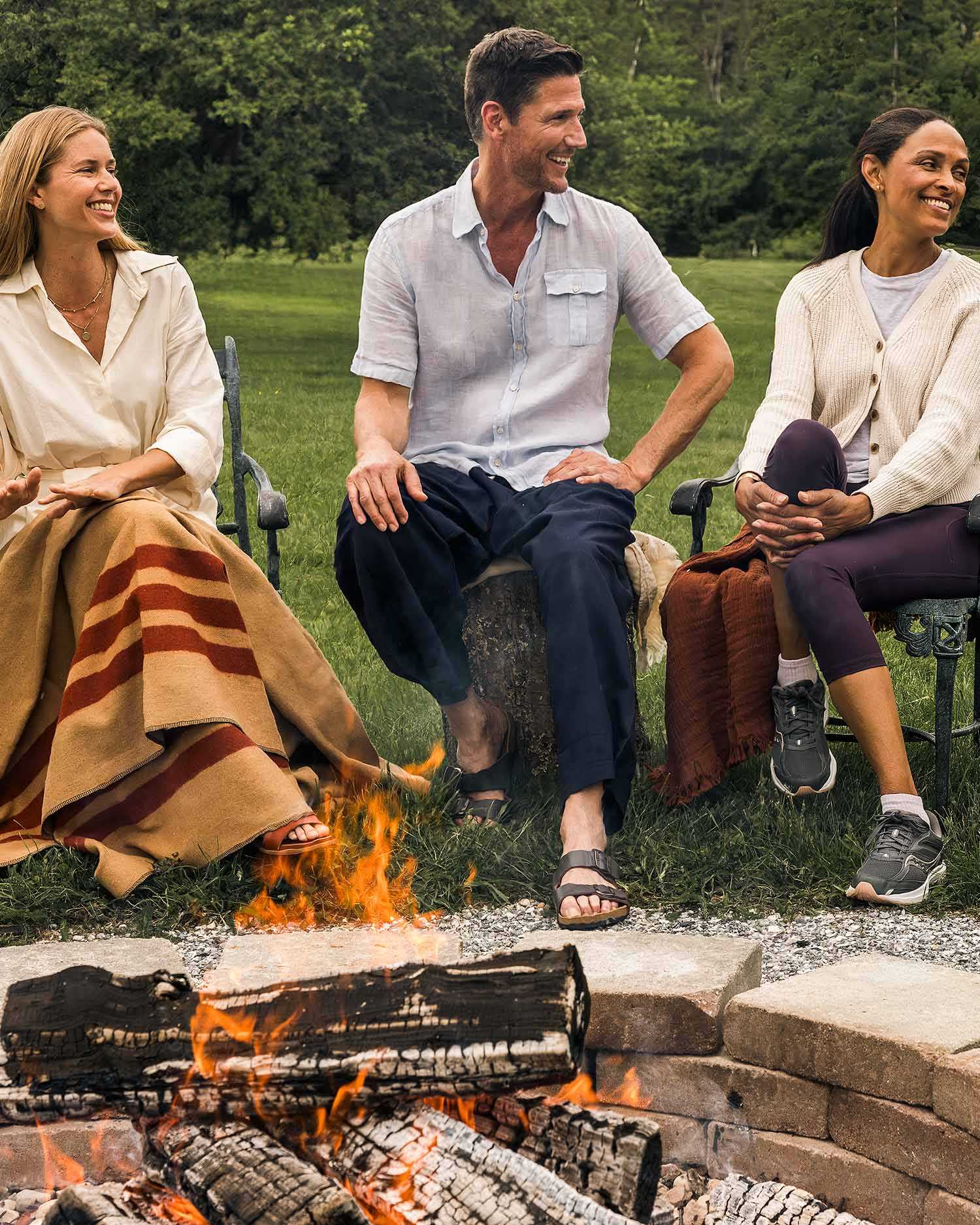 a group of adults around a camp fire