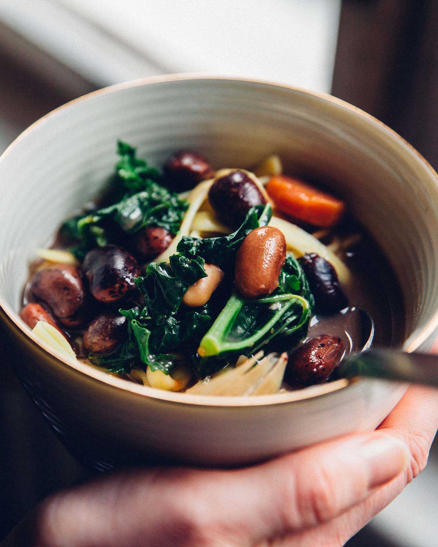 a person holding a bowl of vegetables