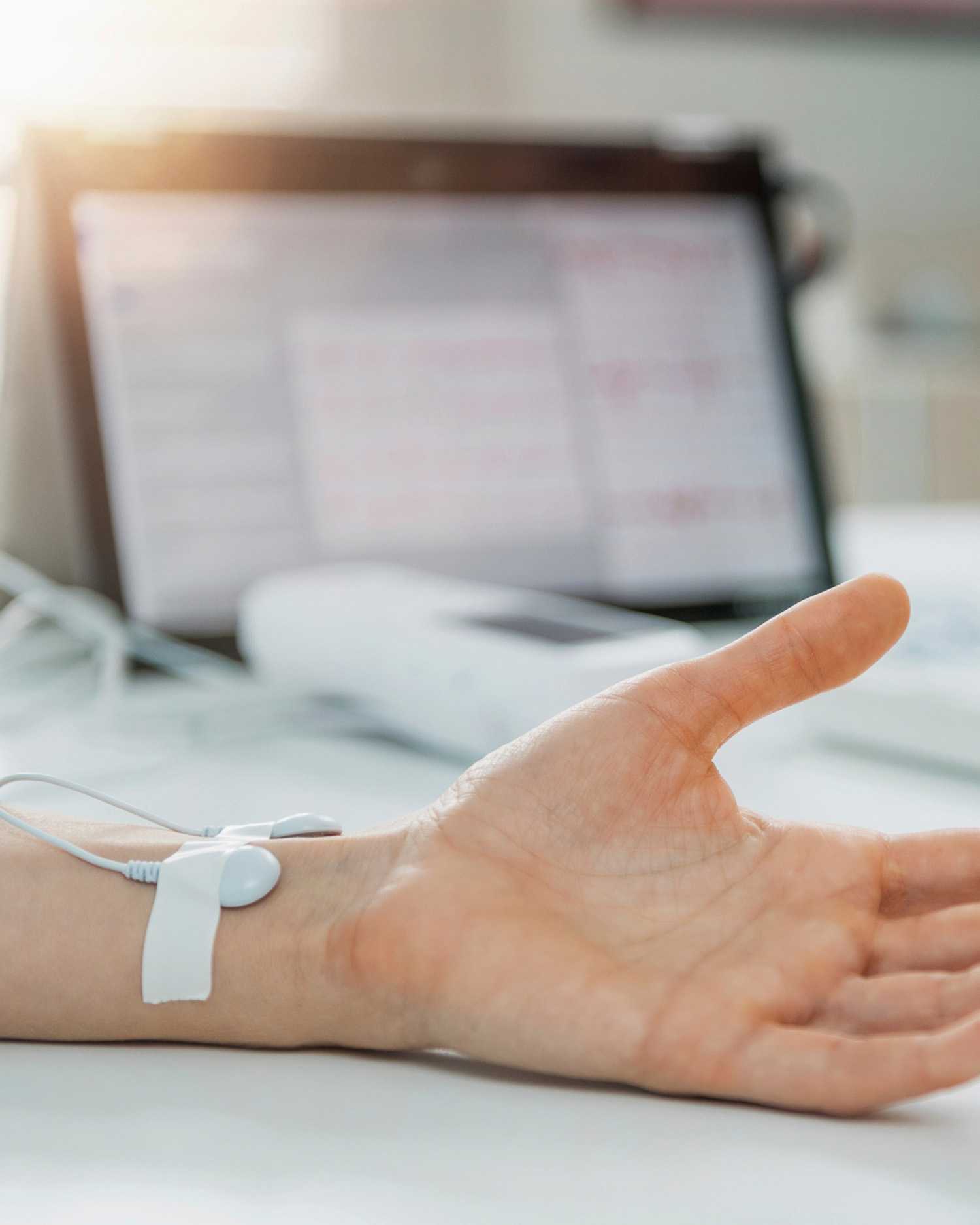 a hand hooked up to a monitor