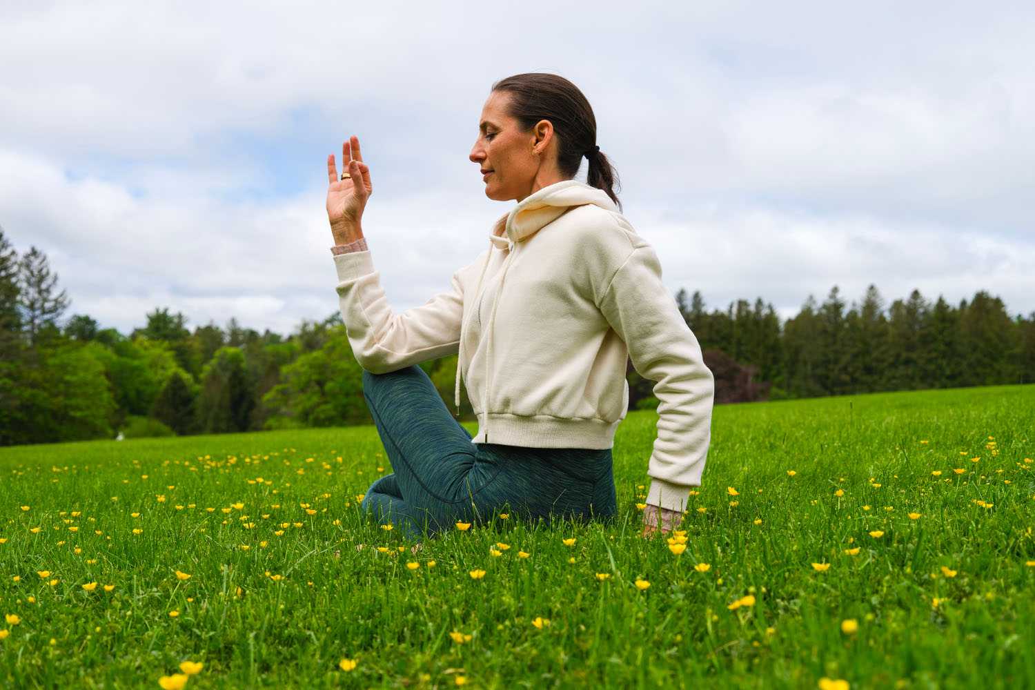a woman doing yoga in a field of flowers