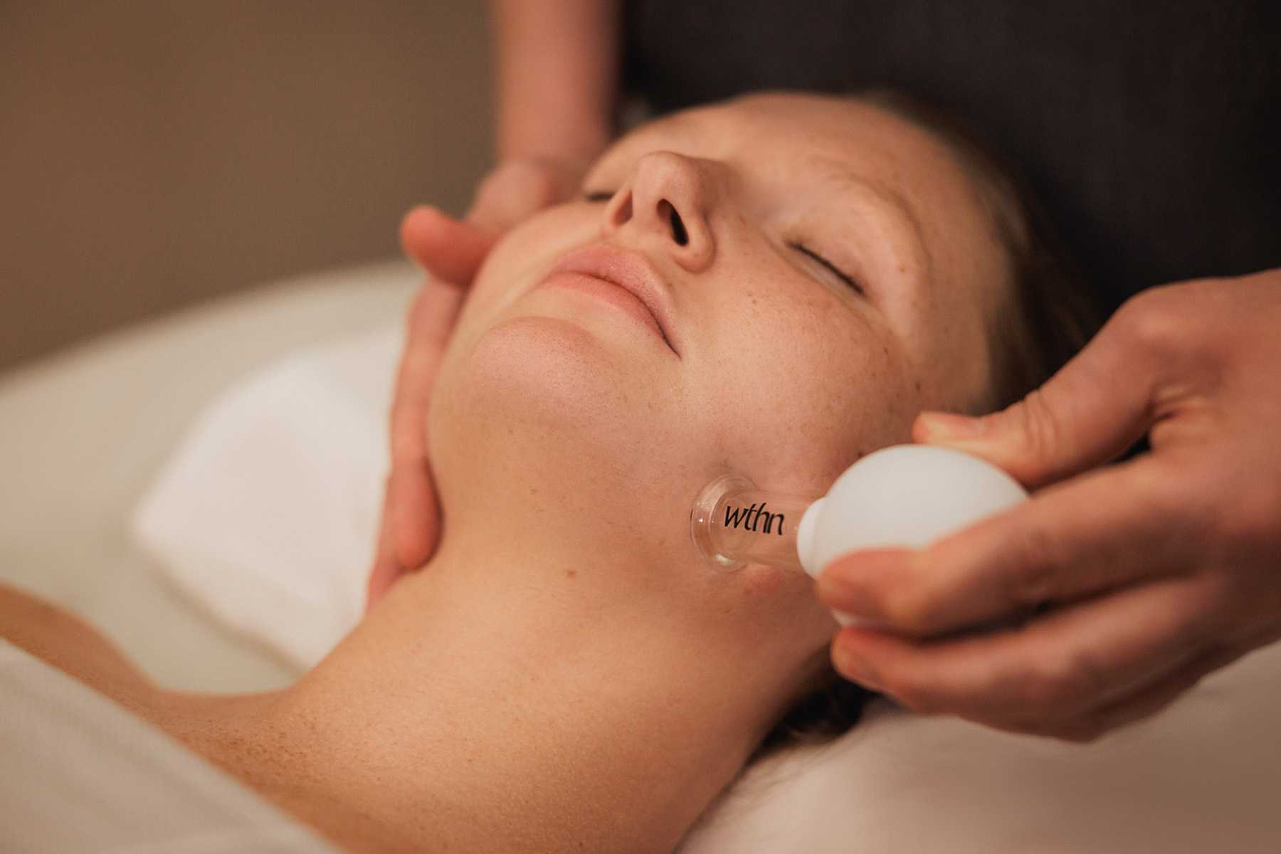a girl getting a facial cupping service