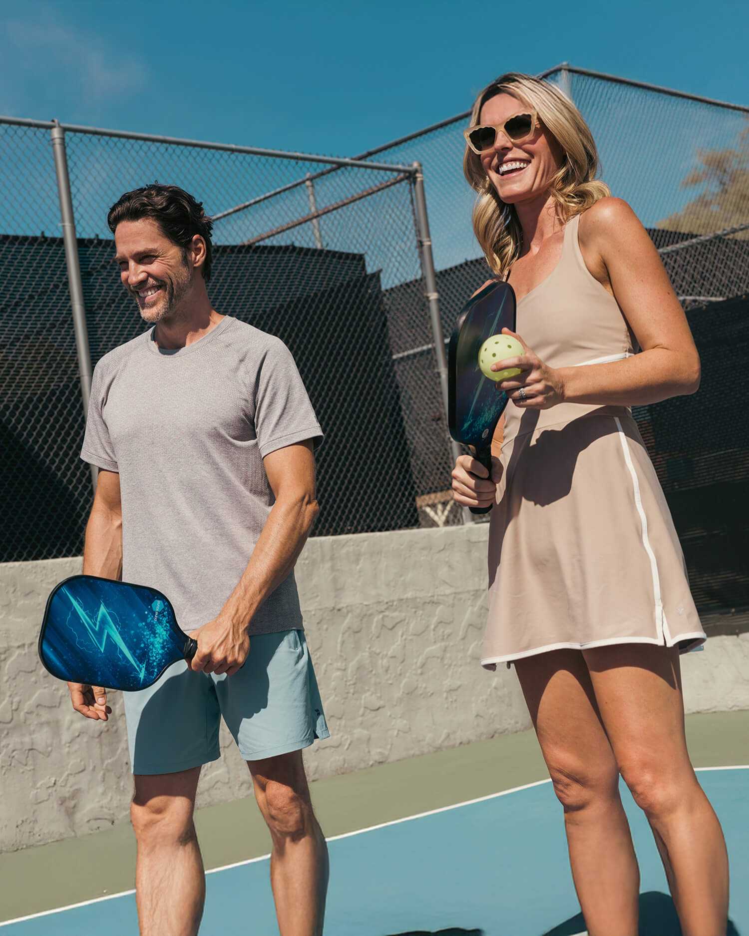 A man and woman playing pickleball