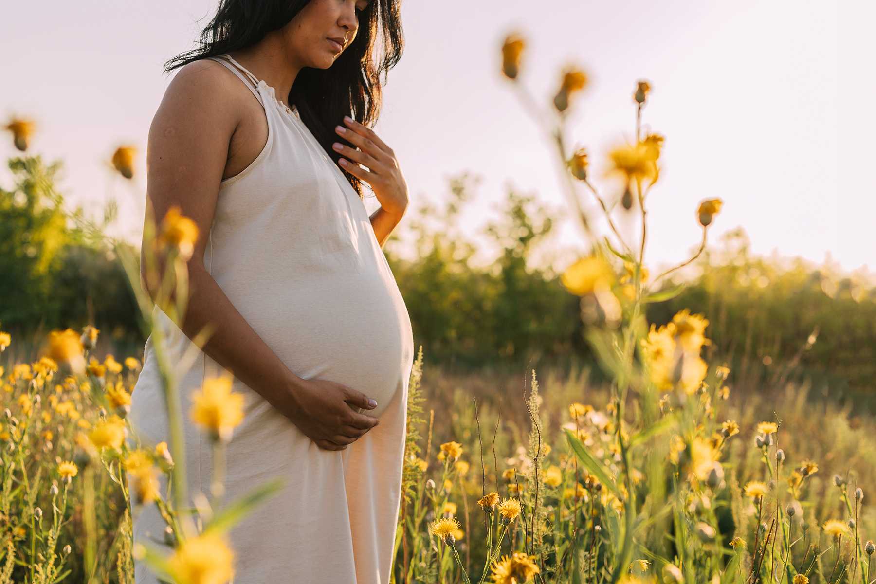 a pregnant woman in a field of flowers