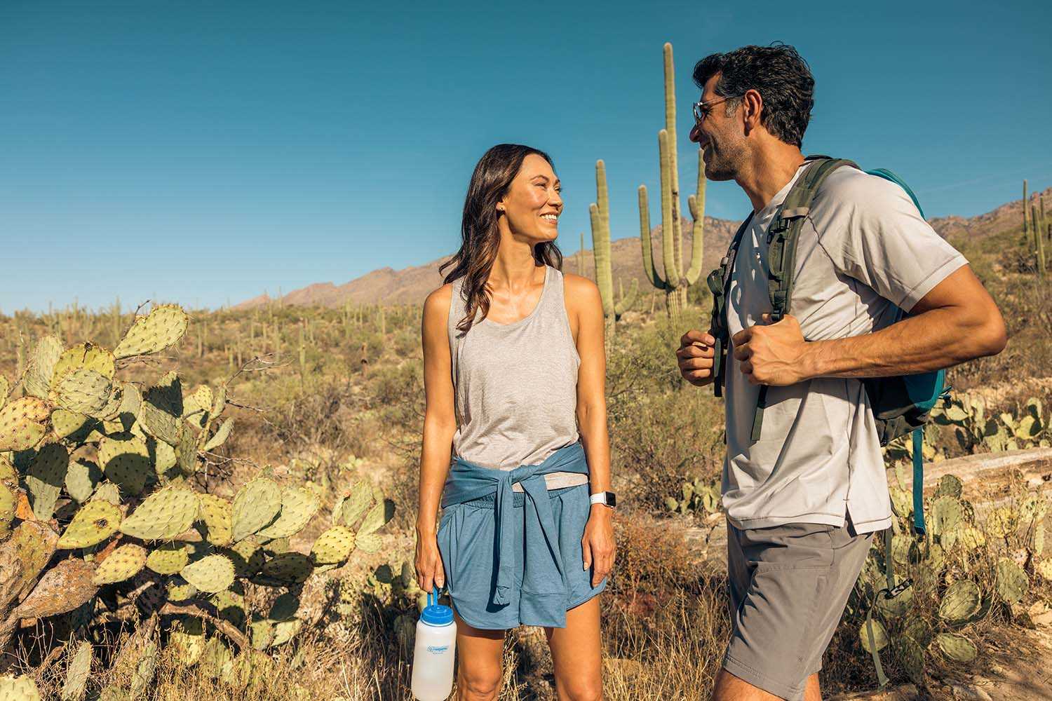 A man and woman hiking in the desert