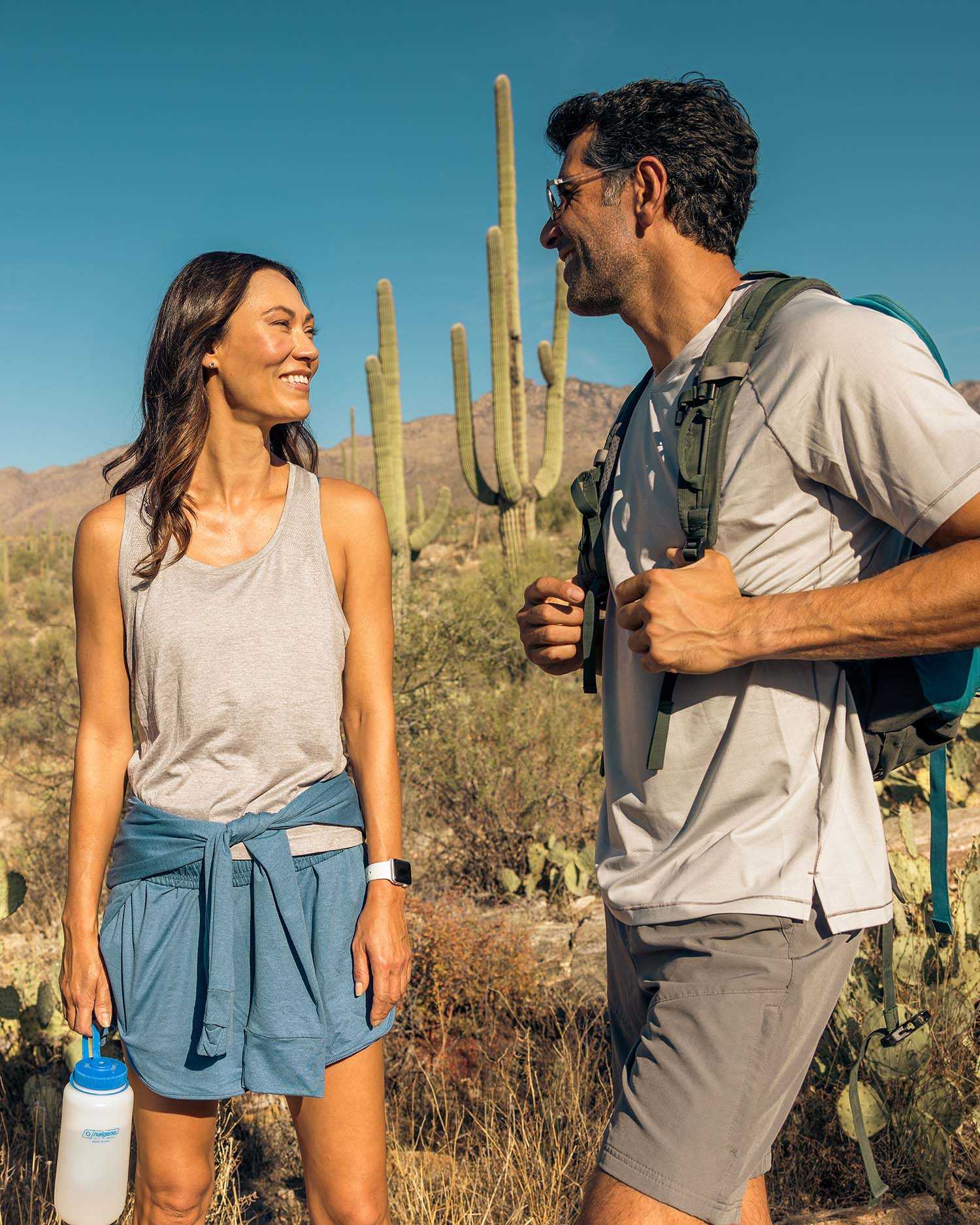 A man and woman hiking in the desert