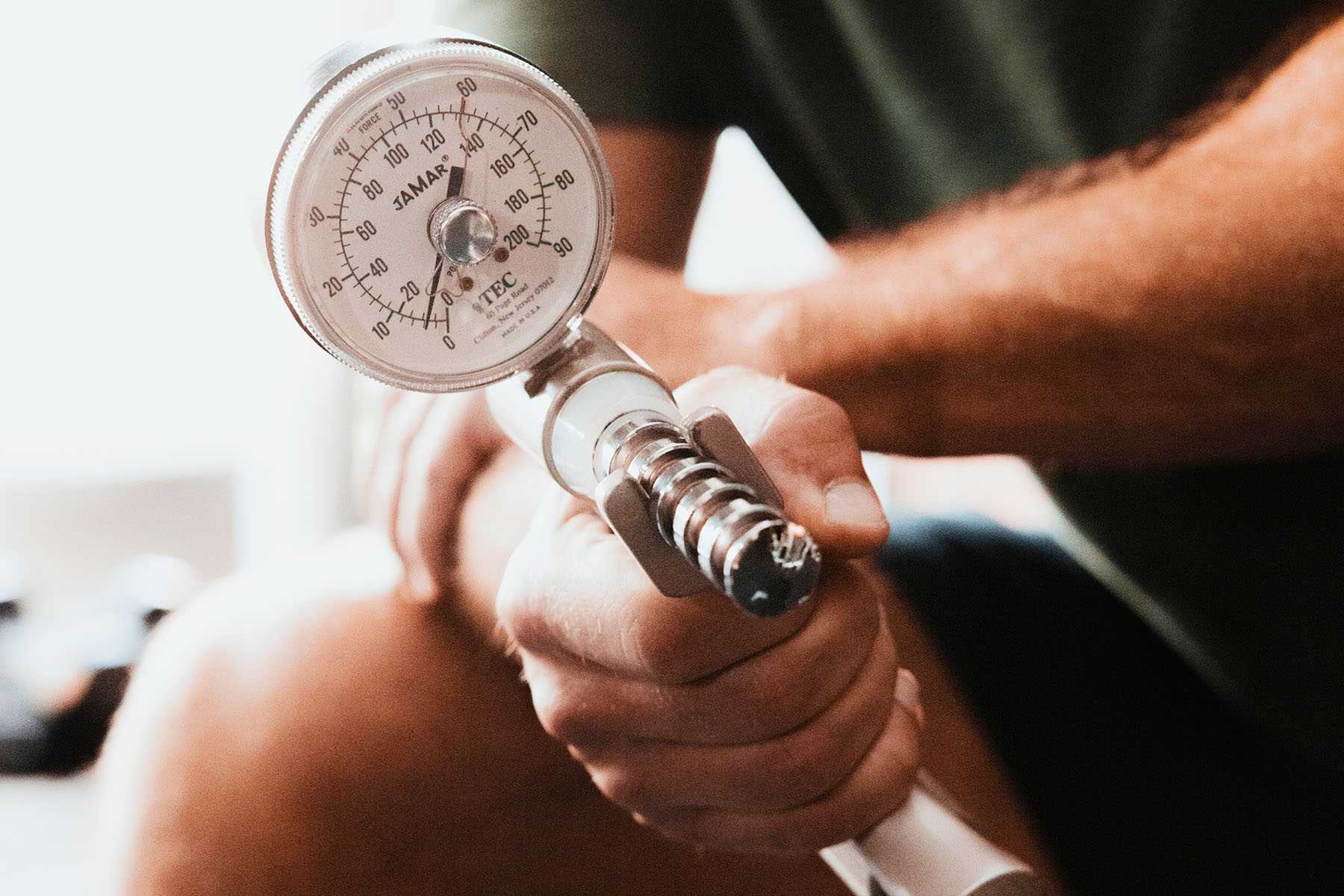a man testing his grip strength on a machine