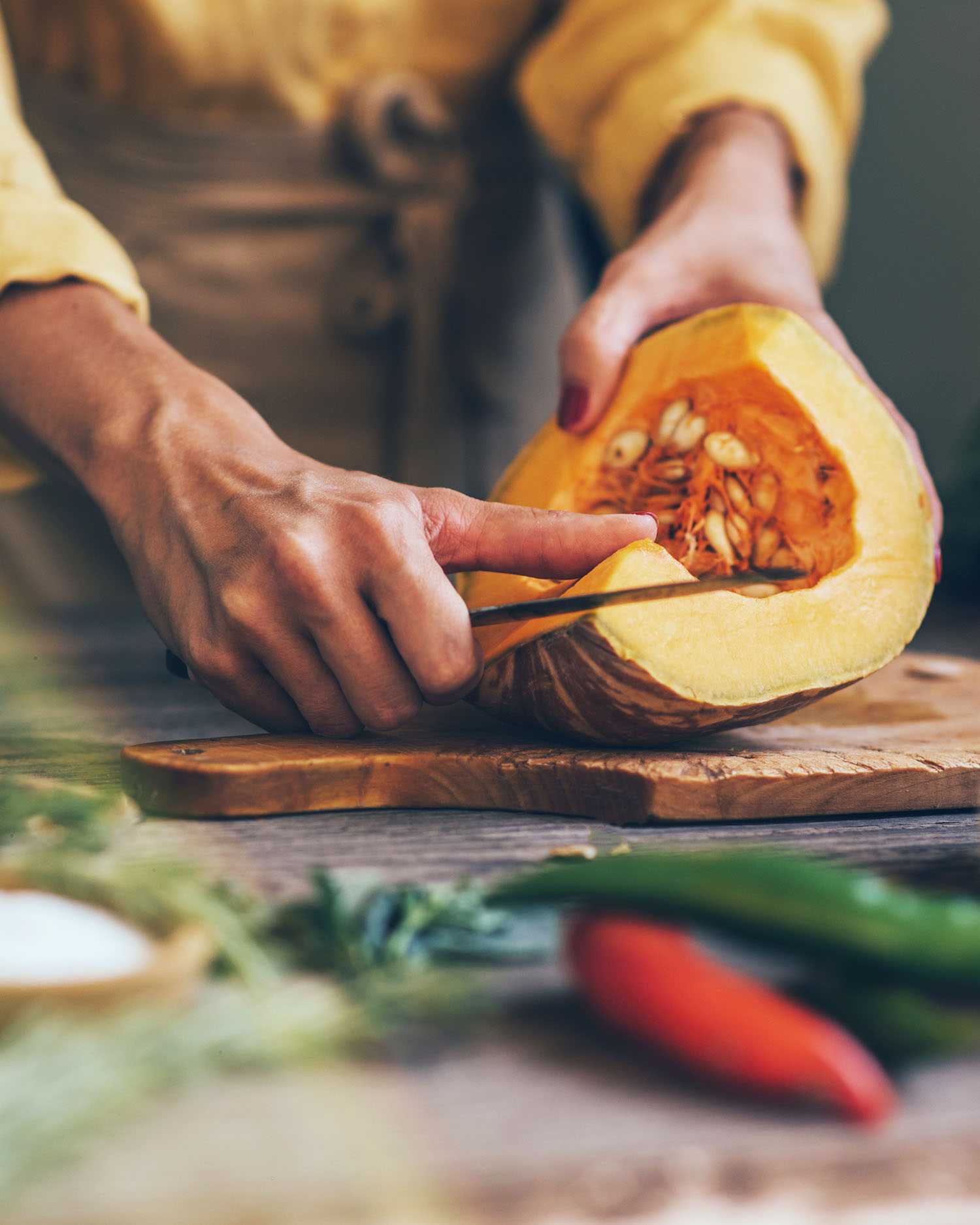 a woman cleaning seed out of ingredients