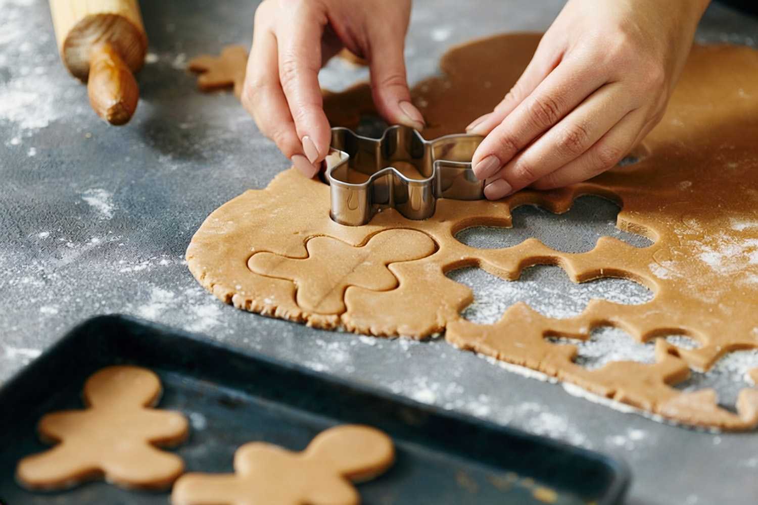 a woman cutting gingerbread men out of dough