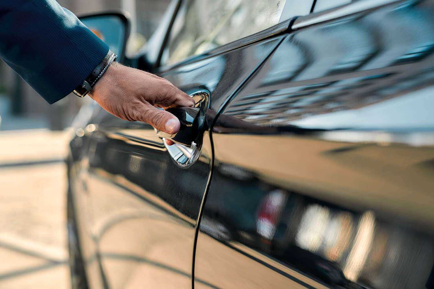 A man opening a door for black car services