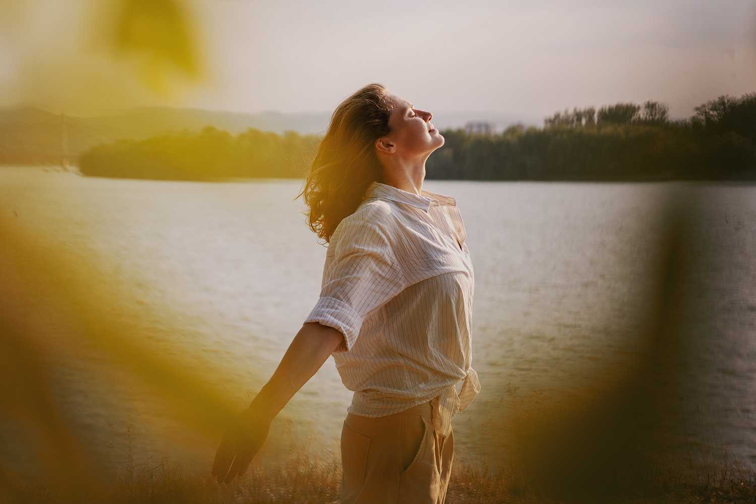 a woman meditating on a lake shore at Canyon Ranch Lenox