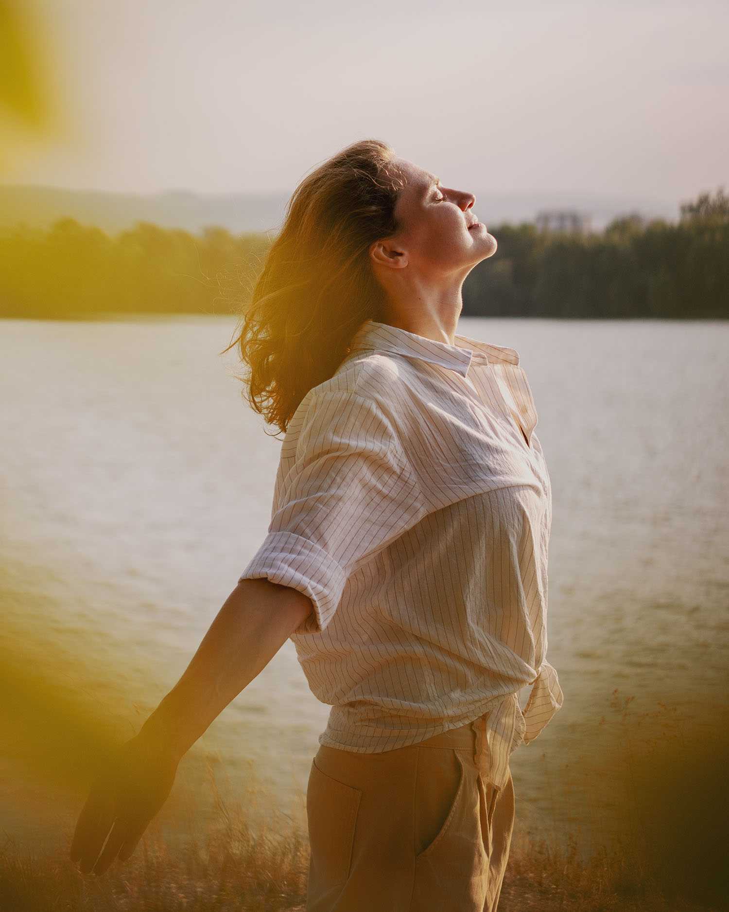 a woman meditating on a lake shore at Canyon Ranch Lenox