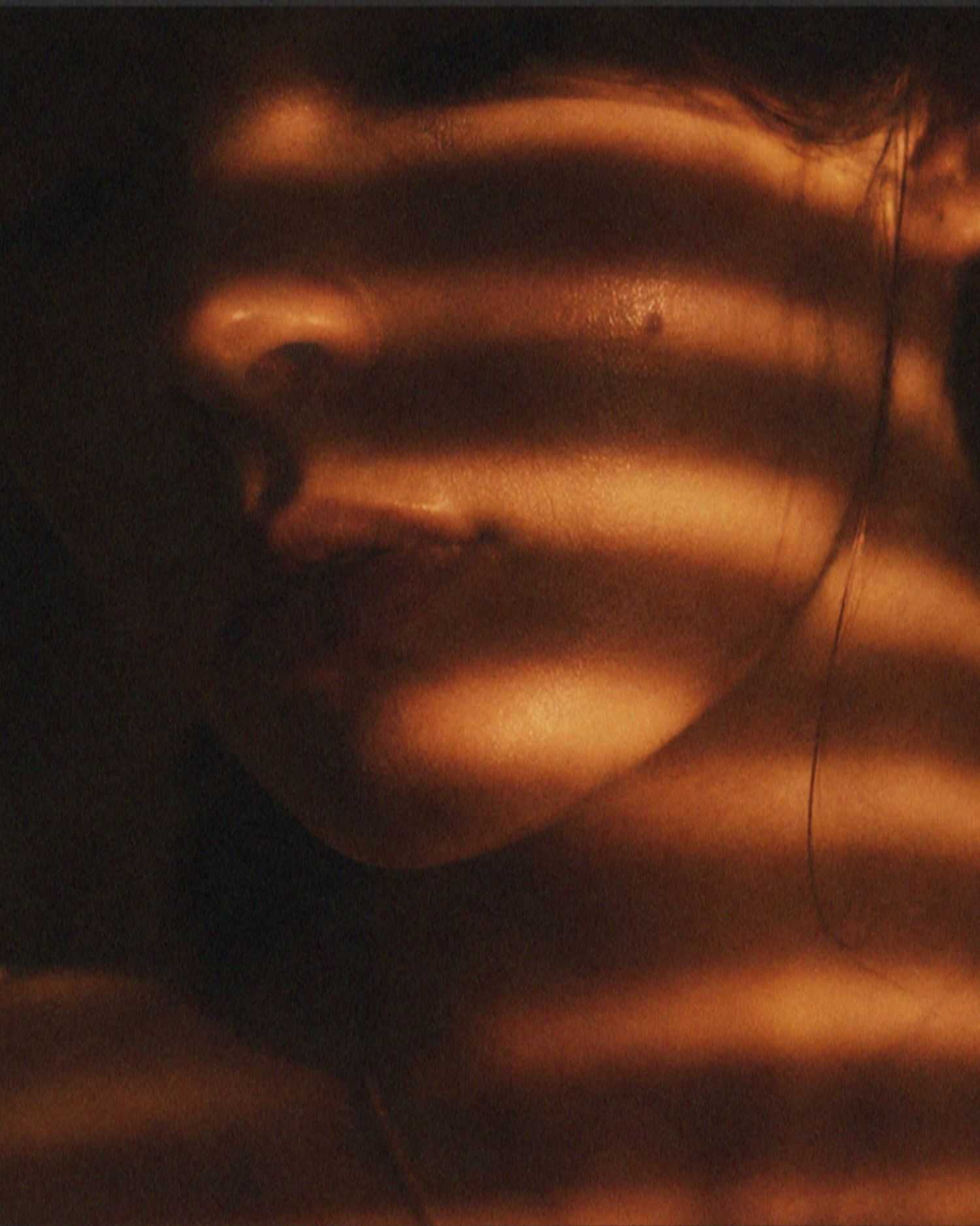 A close up image of a woman in shadows