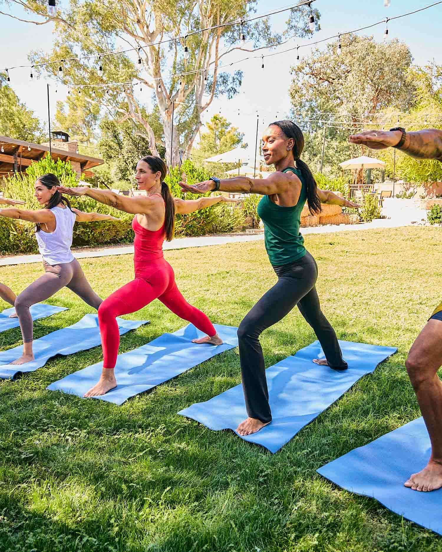 A Group Practicing Yoga Together Outdoors 