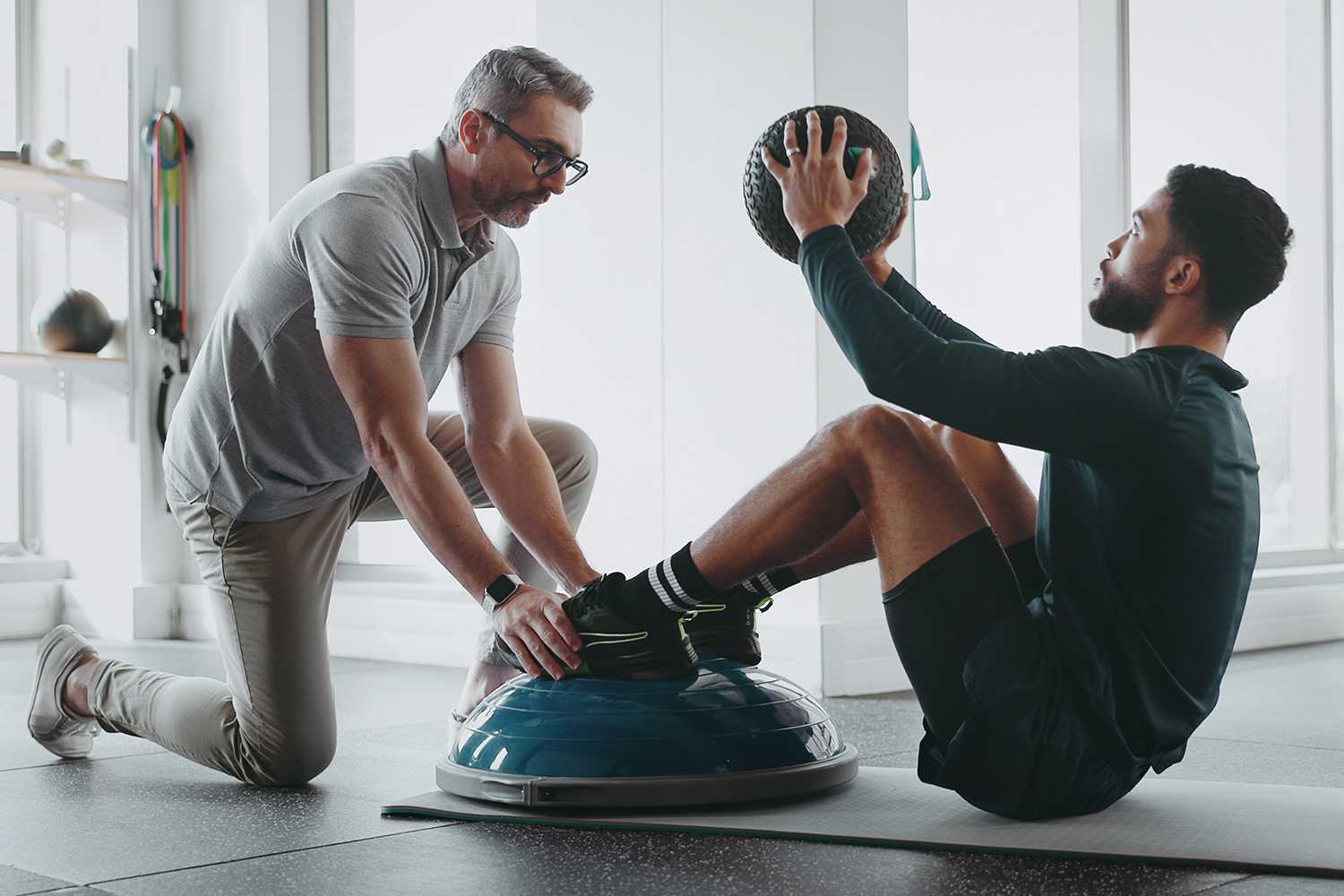 Man Training With Personal Trainer
