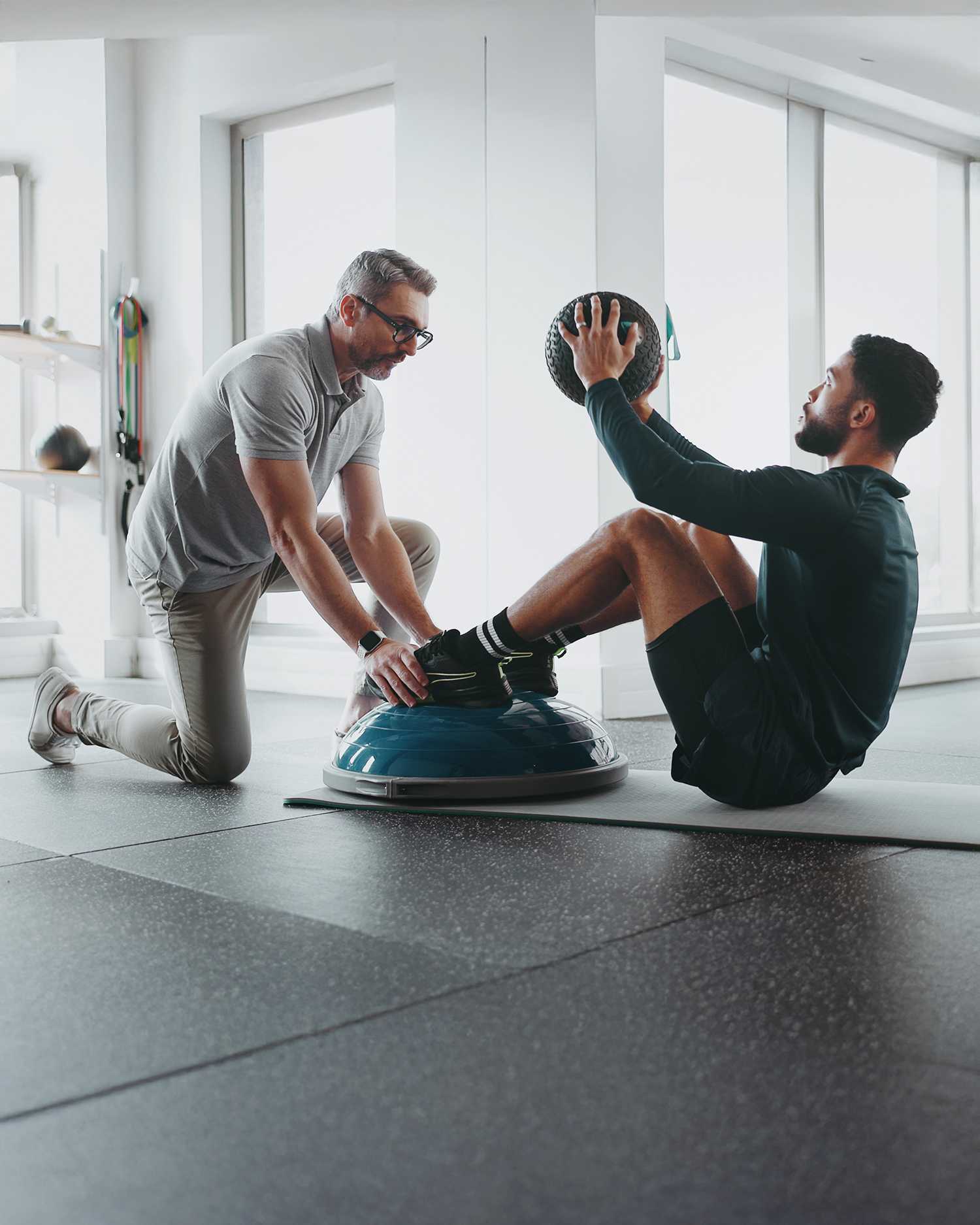 Man Training With Personal Trainer