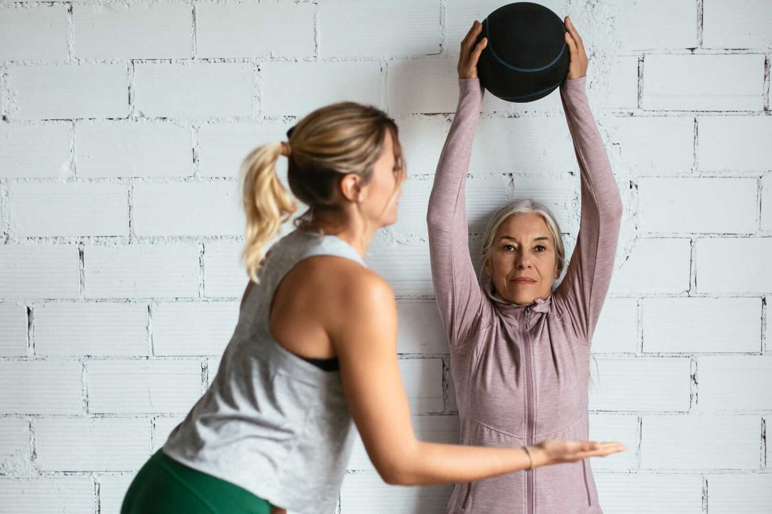 Woman Holding a Medicine Ball During Personal Training