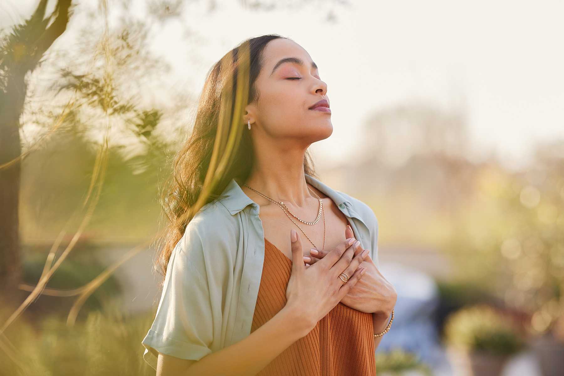 Woman With Eyes Closed Meditating in Nature 