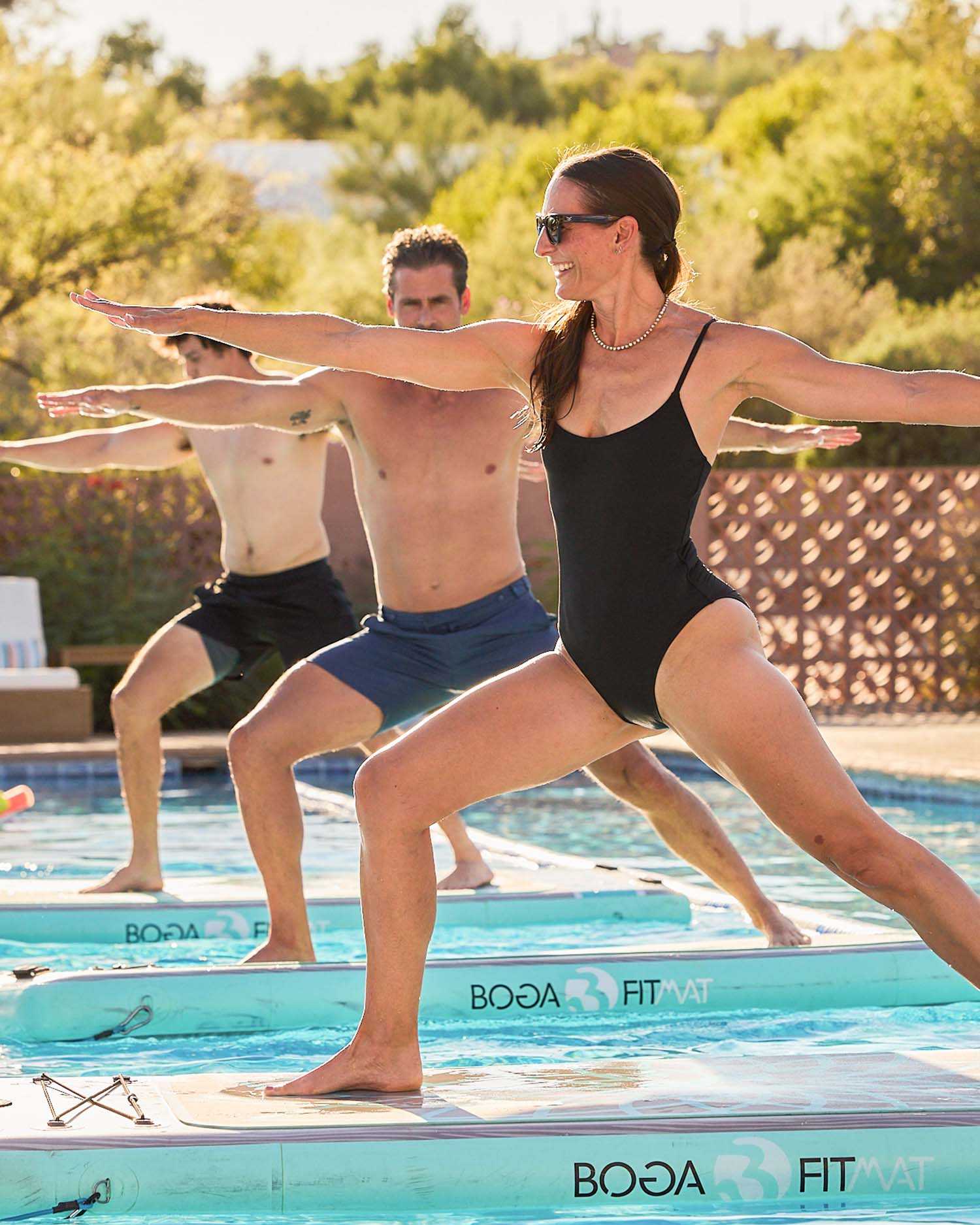 A Group Performing Yoga on a BOGA Fit Mat on Water