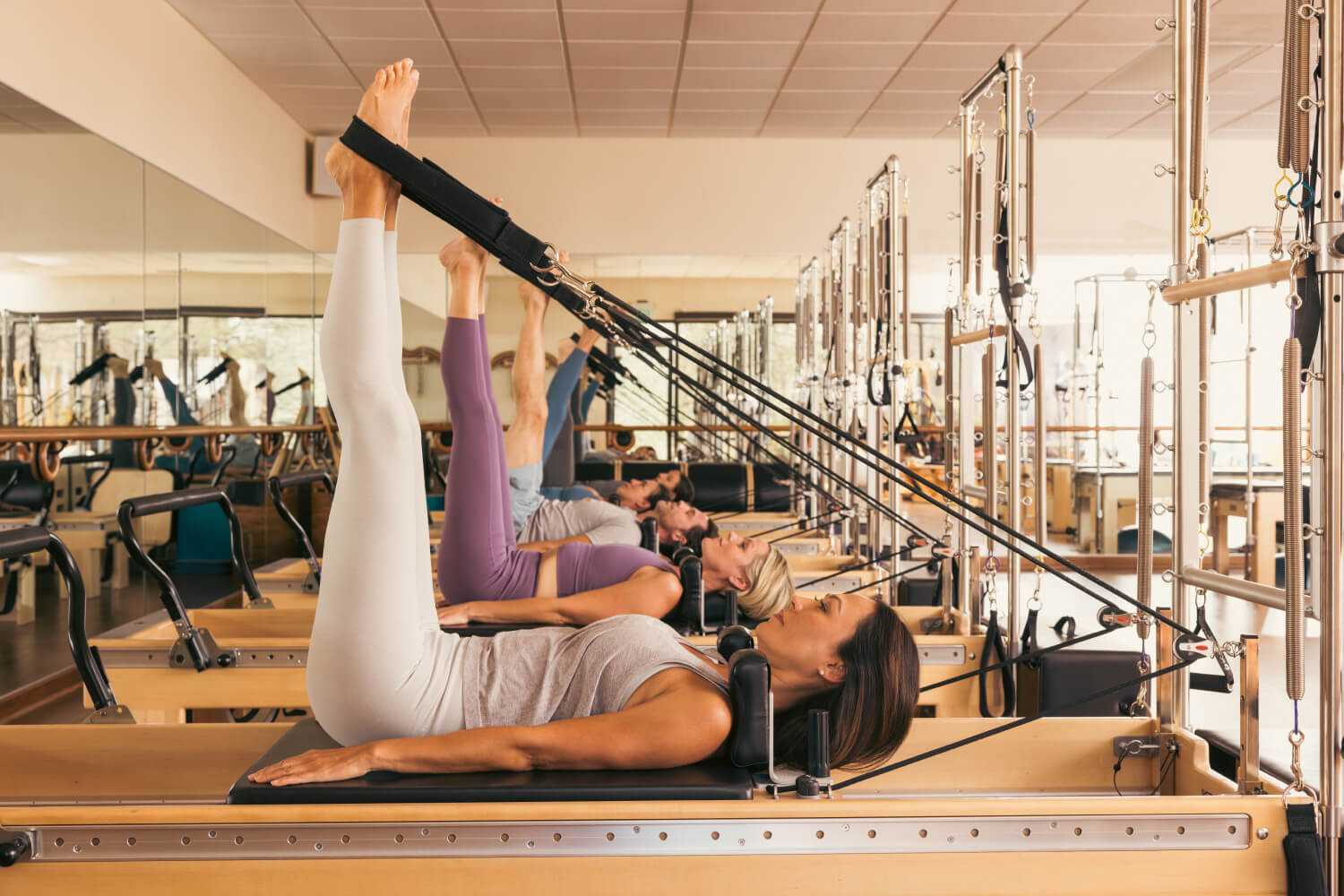 A Group of Women Doing a Reformer Pilates Class