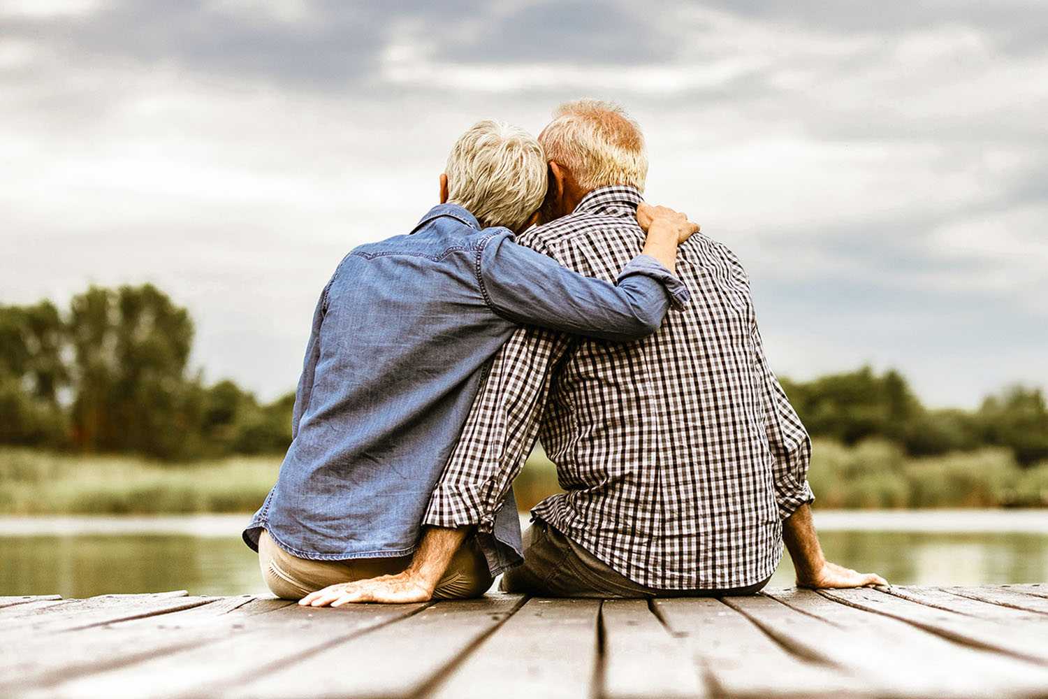 An Older Couple Hugging Watching Out On Nature