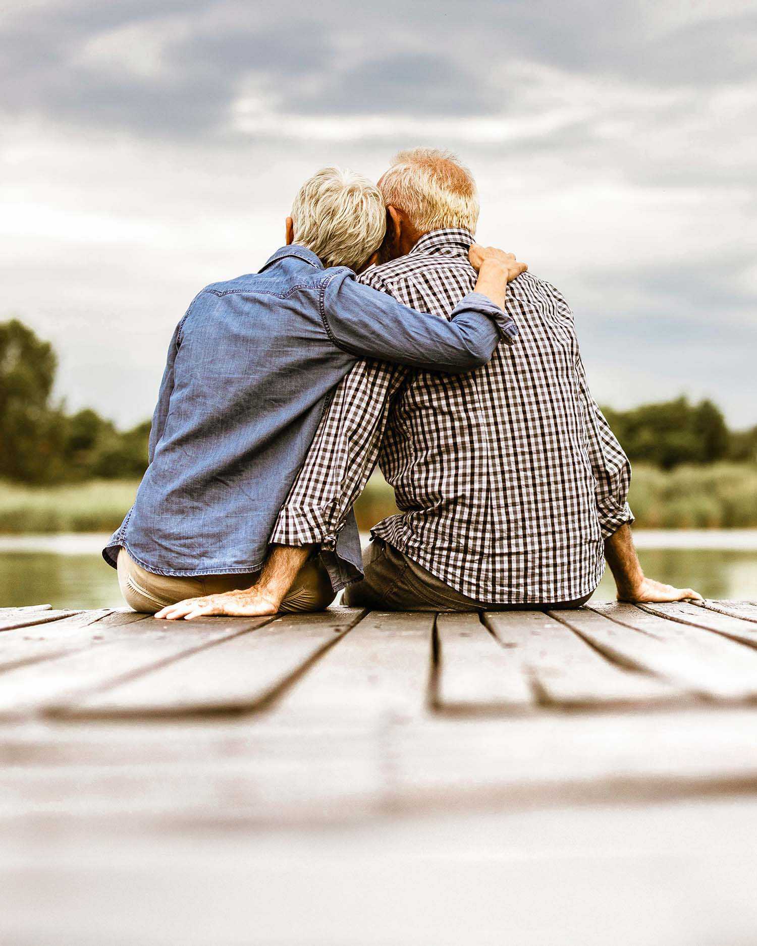 An Older Couple Hugging Watching Out On Nature