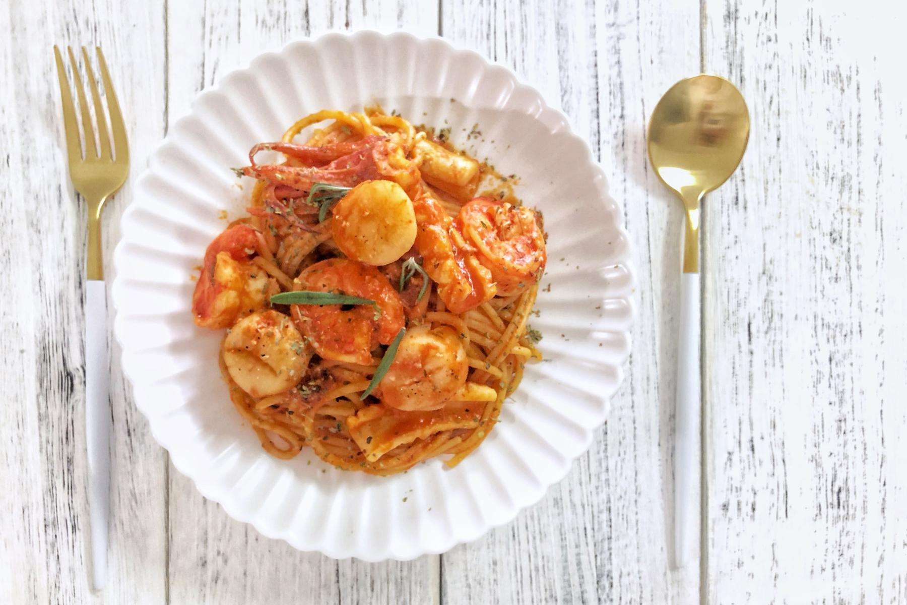 Overhead view of shrimp Catalan dish on white plate.