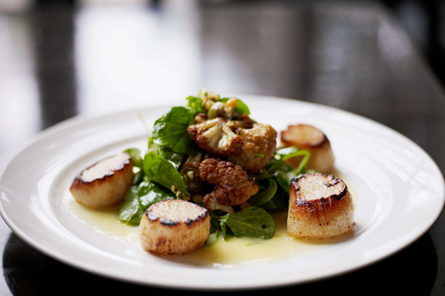 Plate with seared scallops.