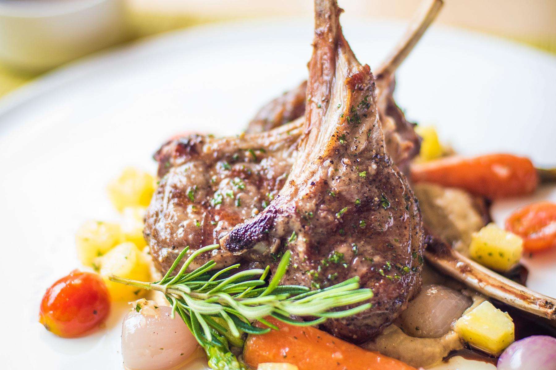 Close-up of a plate with grilled lamb chops.