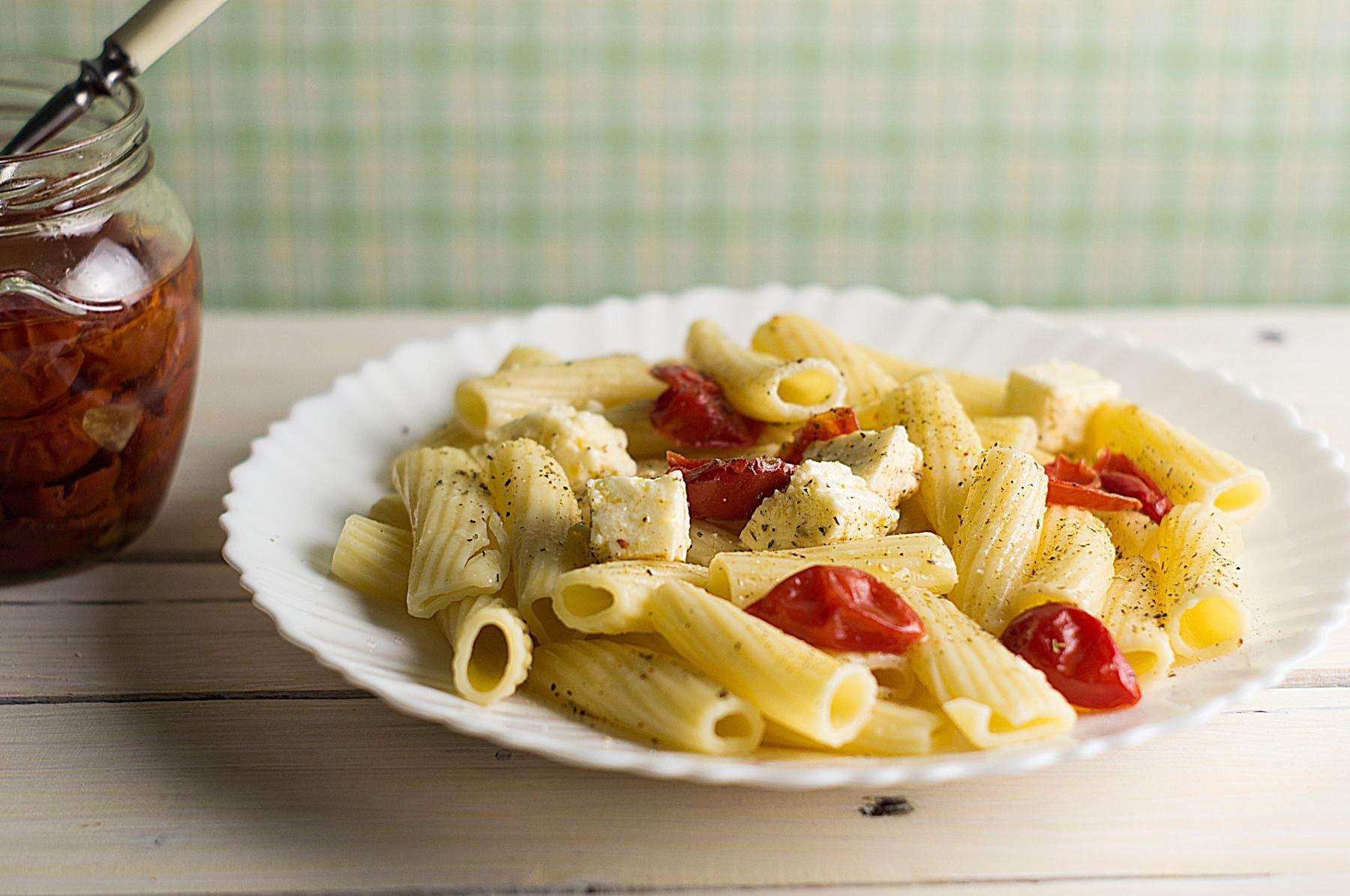 A bowl of sun-dried tomato pasta with feta cheese.
