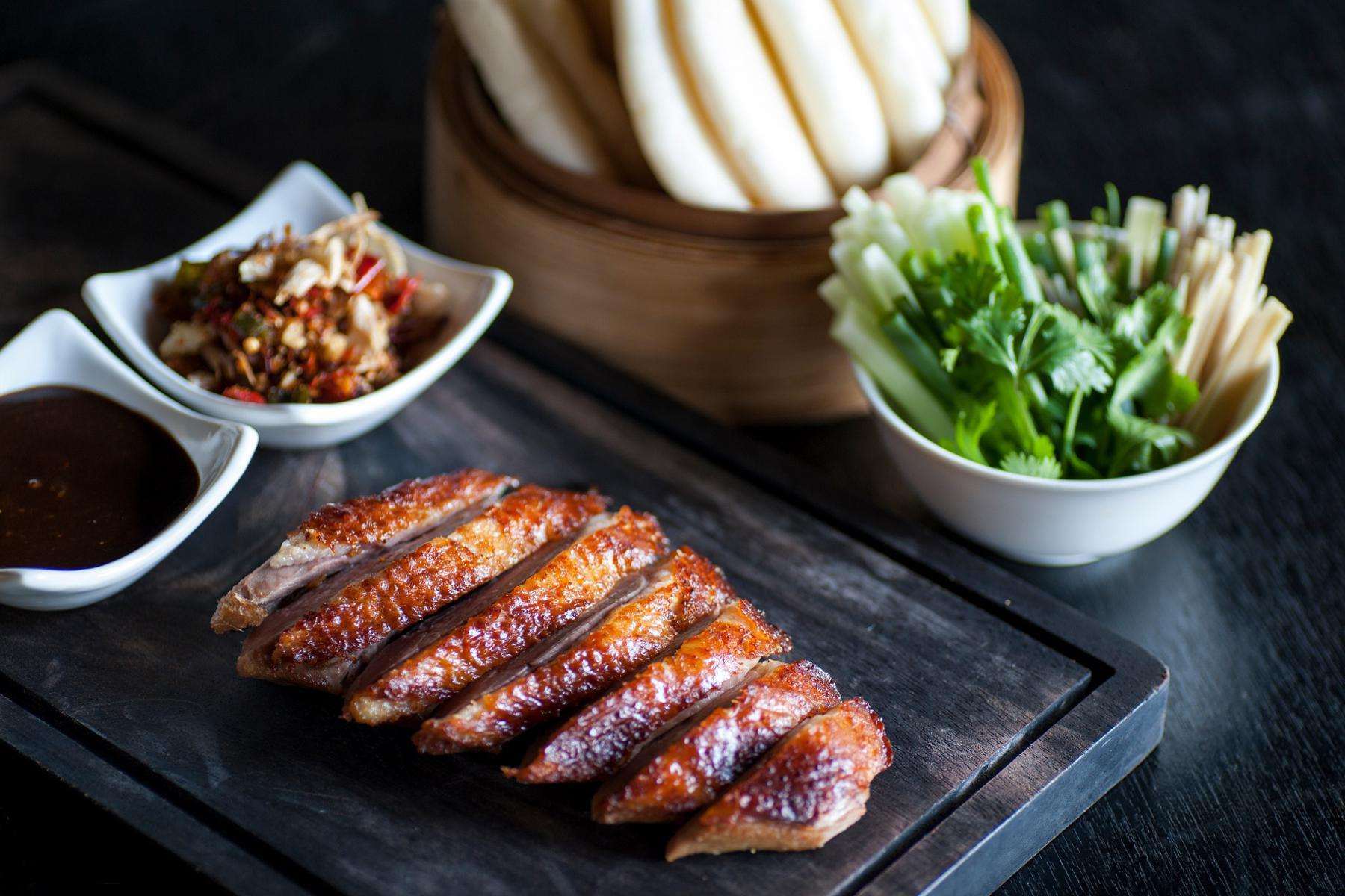 A plate of sauteed Thai duck breast with coconut sauce.