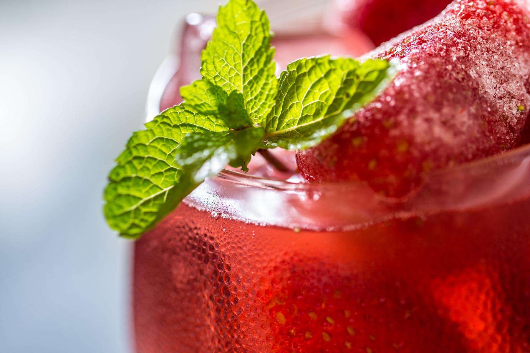 A close-up of a red sparkling fruit soda.