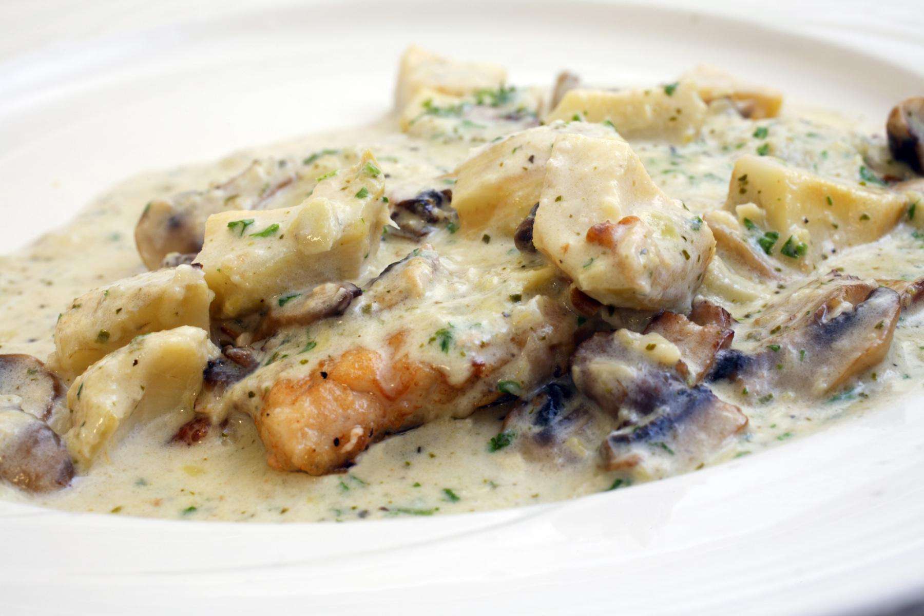 Plate of mediterranean chicken with artichokes.