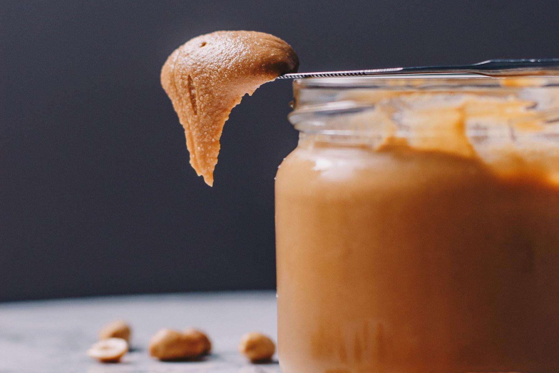 Close-up of glass jar of peanut butter.