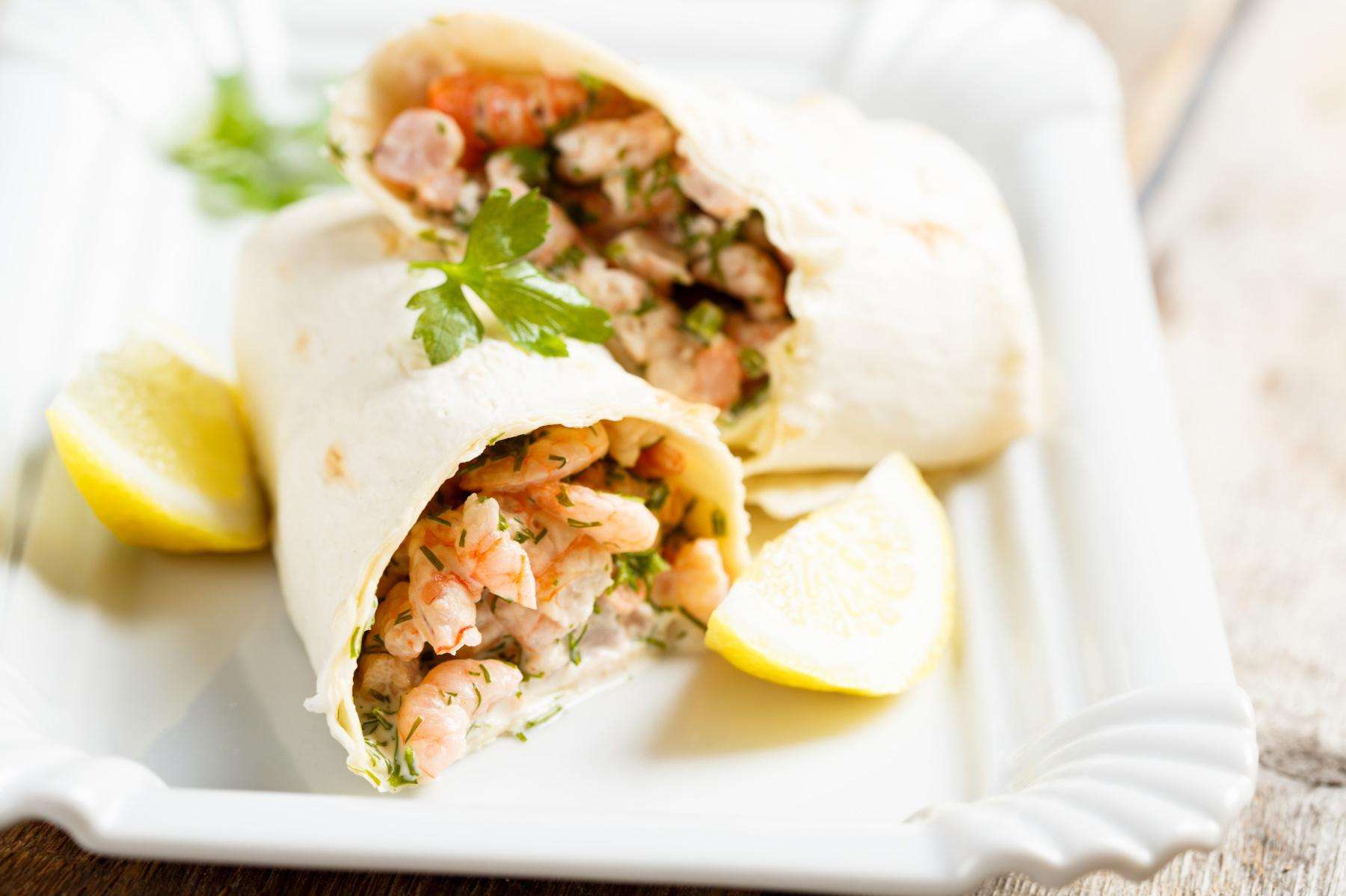 A plate of shrimp cocktail wraps.