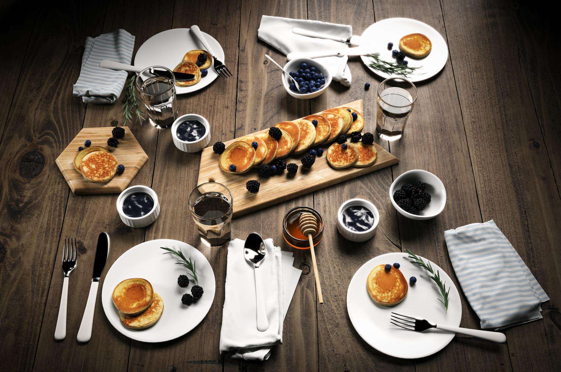 Overhead view of a table with a breakfast spread of pancakes.