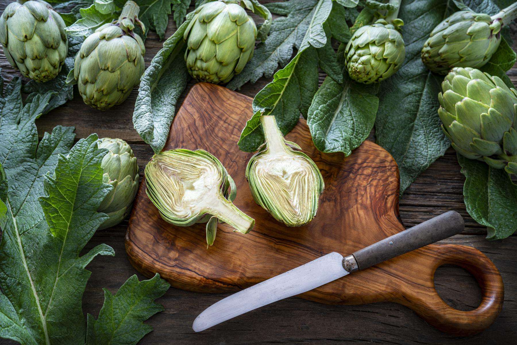 artichoke heads on a chopping board
