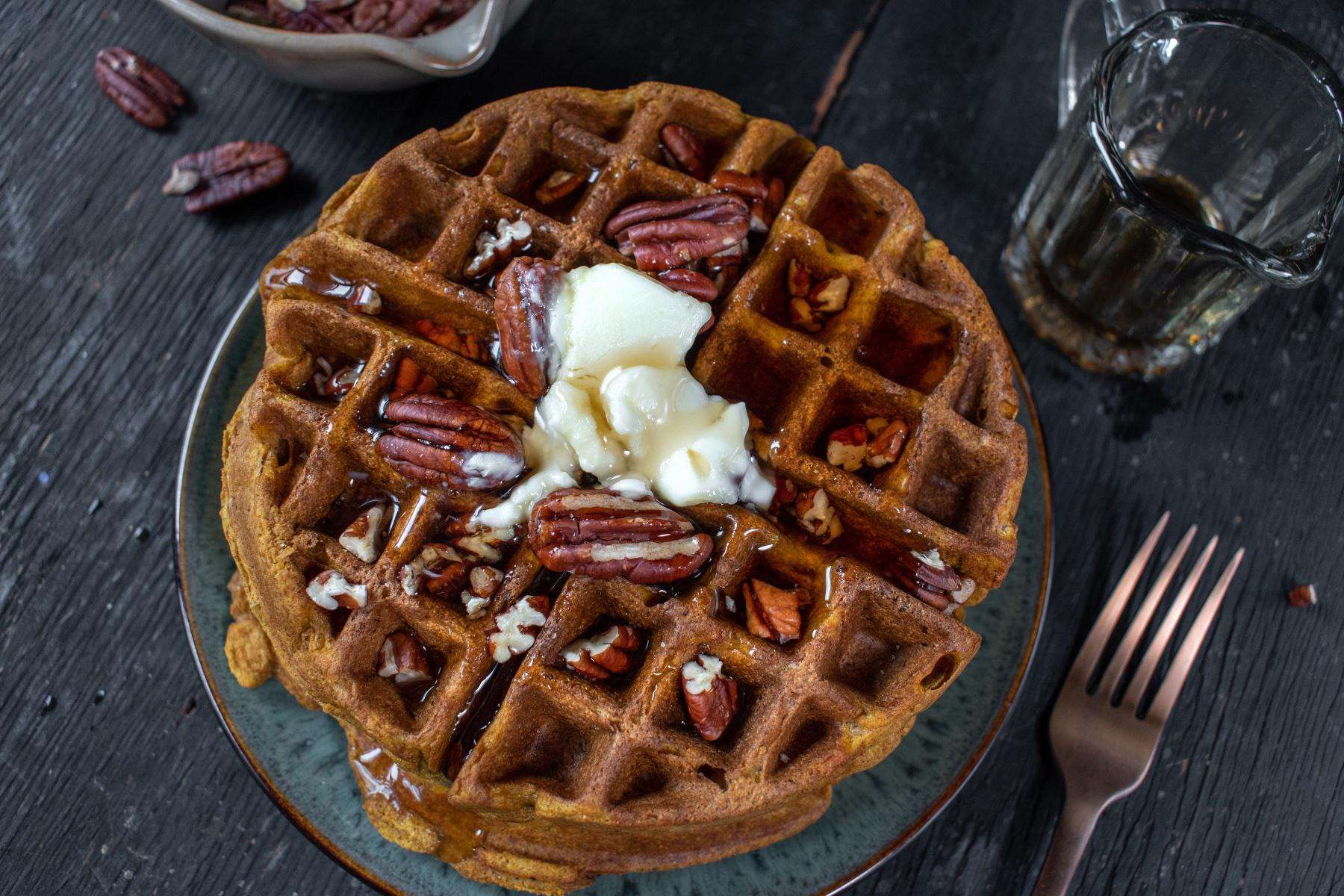 Overhead view of waffle with pecans on top.