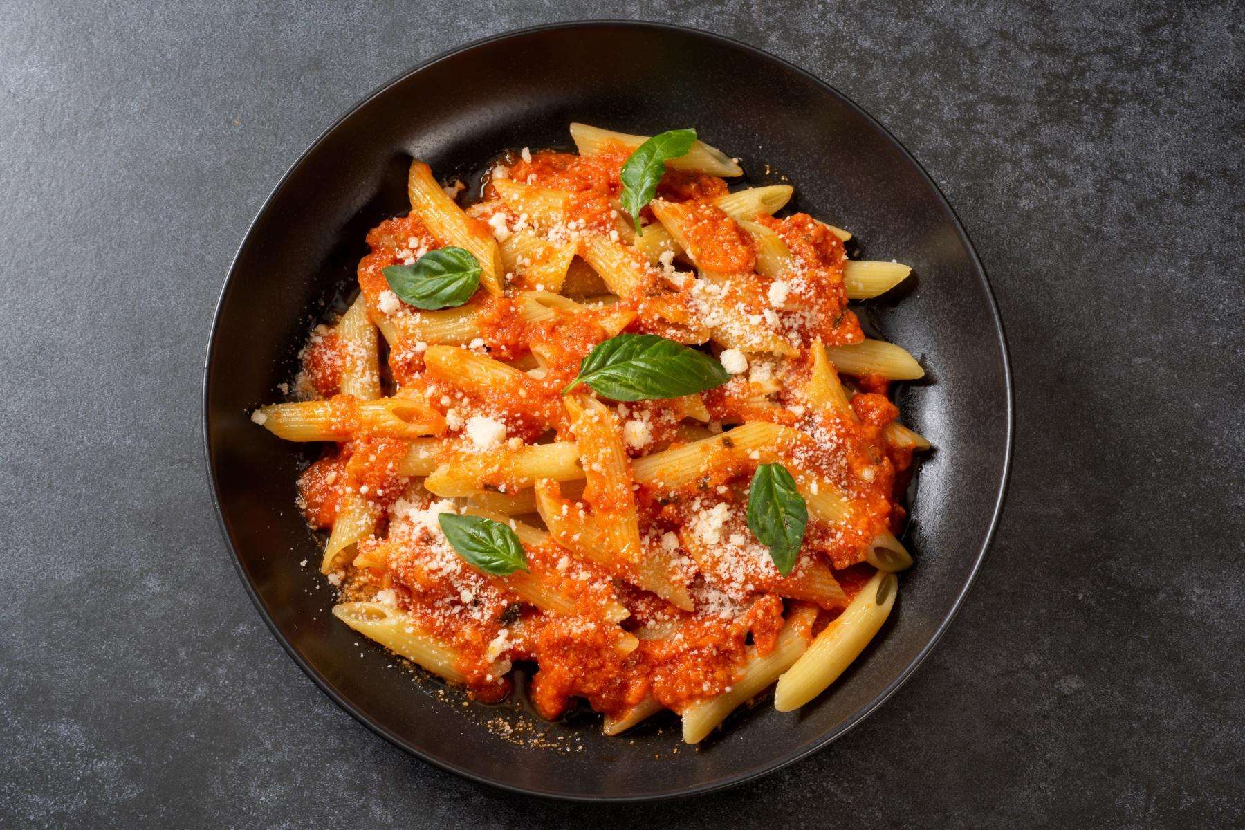 Overhead view of a bowl of pasta with crab and cream sauce.