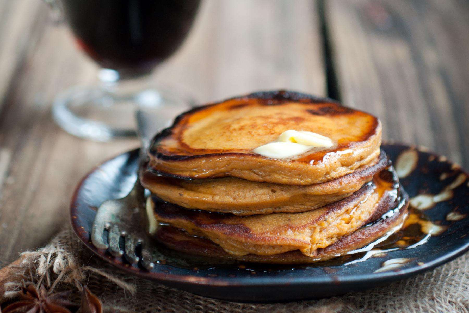 Stack of sweet potato pancakes on plate.