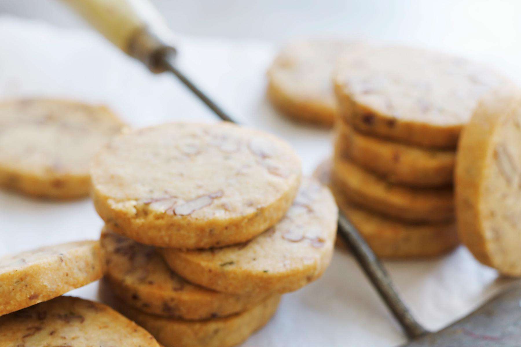A close-up of orange pecan cookies.