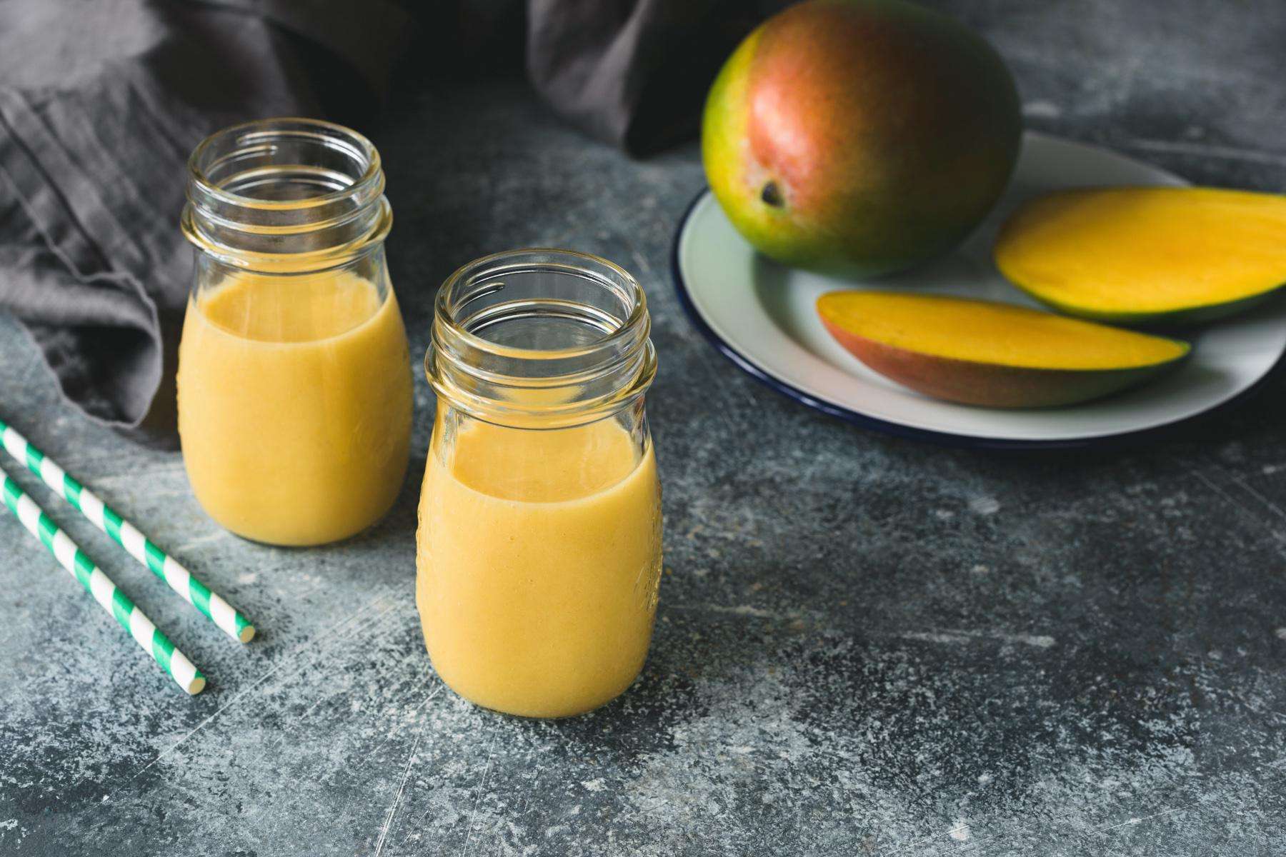 Close-up of tropical orange smoothies in class jars.