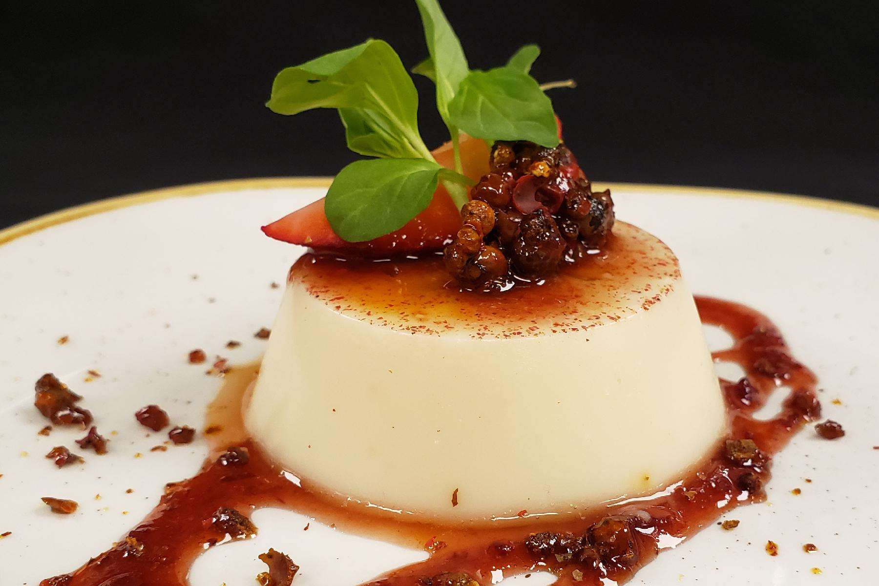 Close-up image of Pink Peppercorn Panna Cotta on a plate.