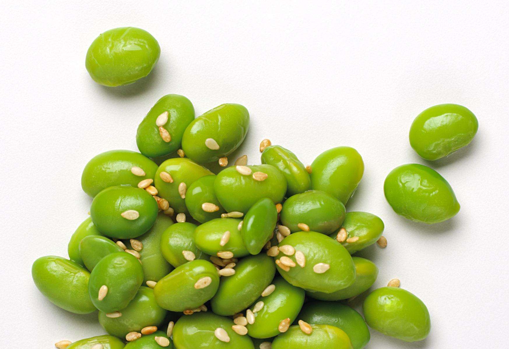 Close-up of soybeans with sesame seeds on them.